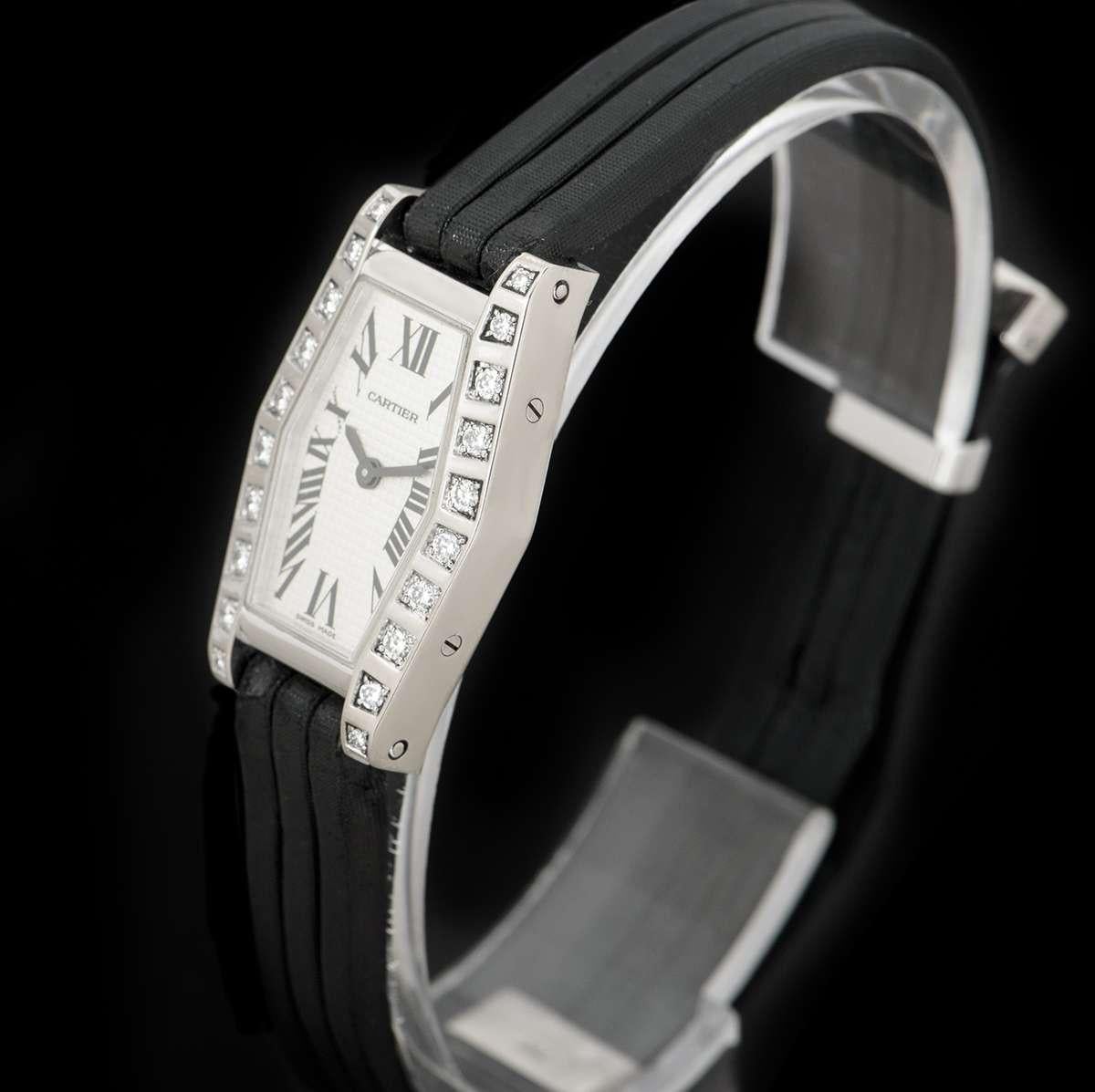 A 18 mm 18k white gold Lanieres women's wristwatch, by Cartier. 

Featuring a silver dial with a sapphire crystal, surrounded by a fixed bezel, set with 20 round brilliant cut diamonds.

The watch comes fitted to a generic black leather strap with
