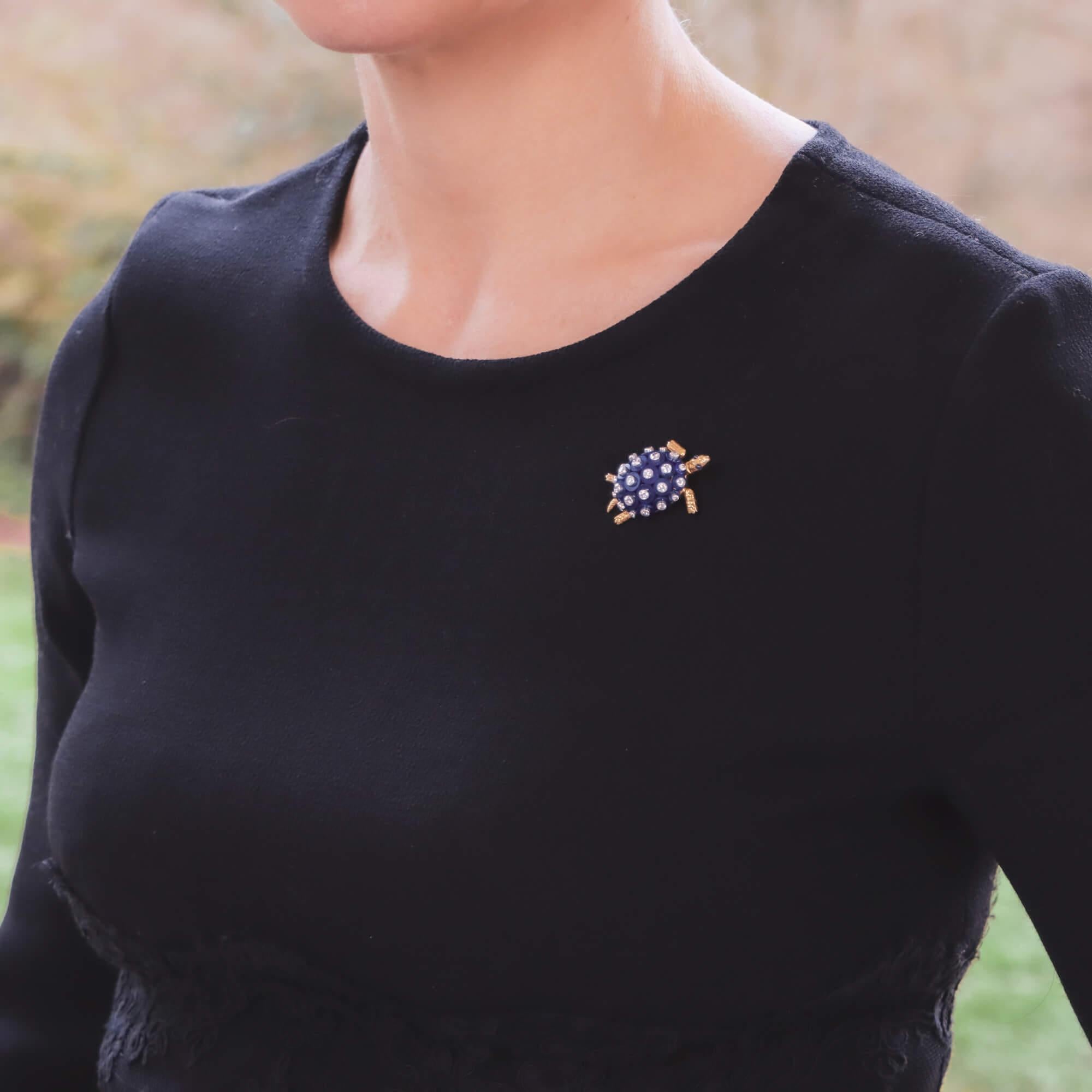 A beautiful Cartier lapis lazuli, diamond and sapphire turtle brooch set in 18k yellow gold and platinum. 

The brooch depicts an elegant swimming turtle with hand engraved yellow gold legs, tail and head. The turtles shell is composed of a number