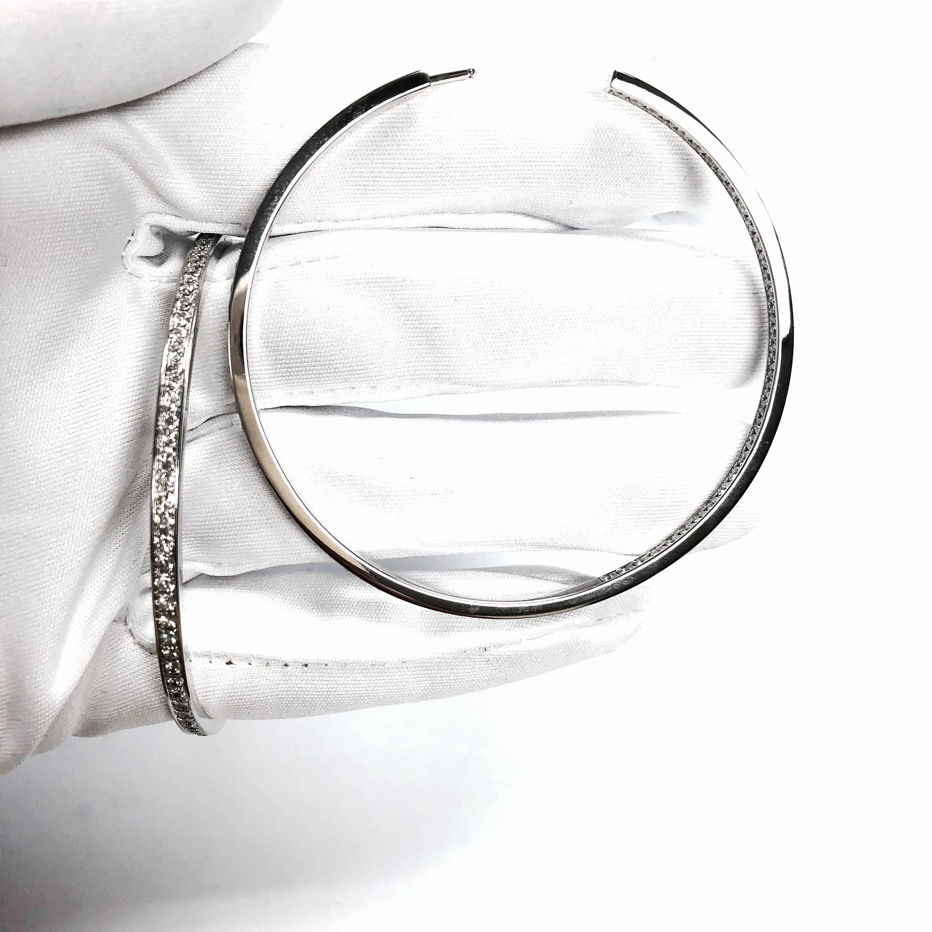 Cartier 18K white gold large diamond inside-out hoop earrings. Each earring is set with 78 round brilliant cut diamonds. 
156 diamonds: approximate total weight: 3.5 carats, Color: F-G, Clarity: VS
Measurements: 2 7/16 inch in diameter. 3 mm