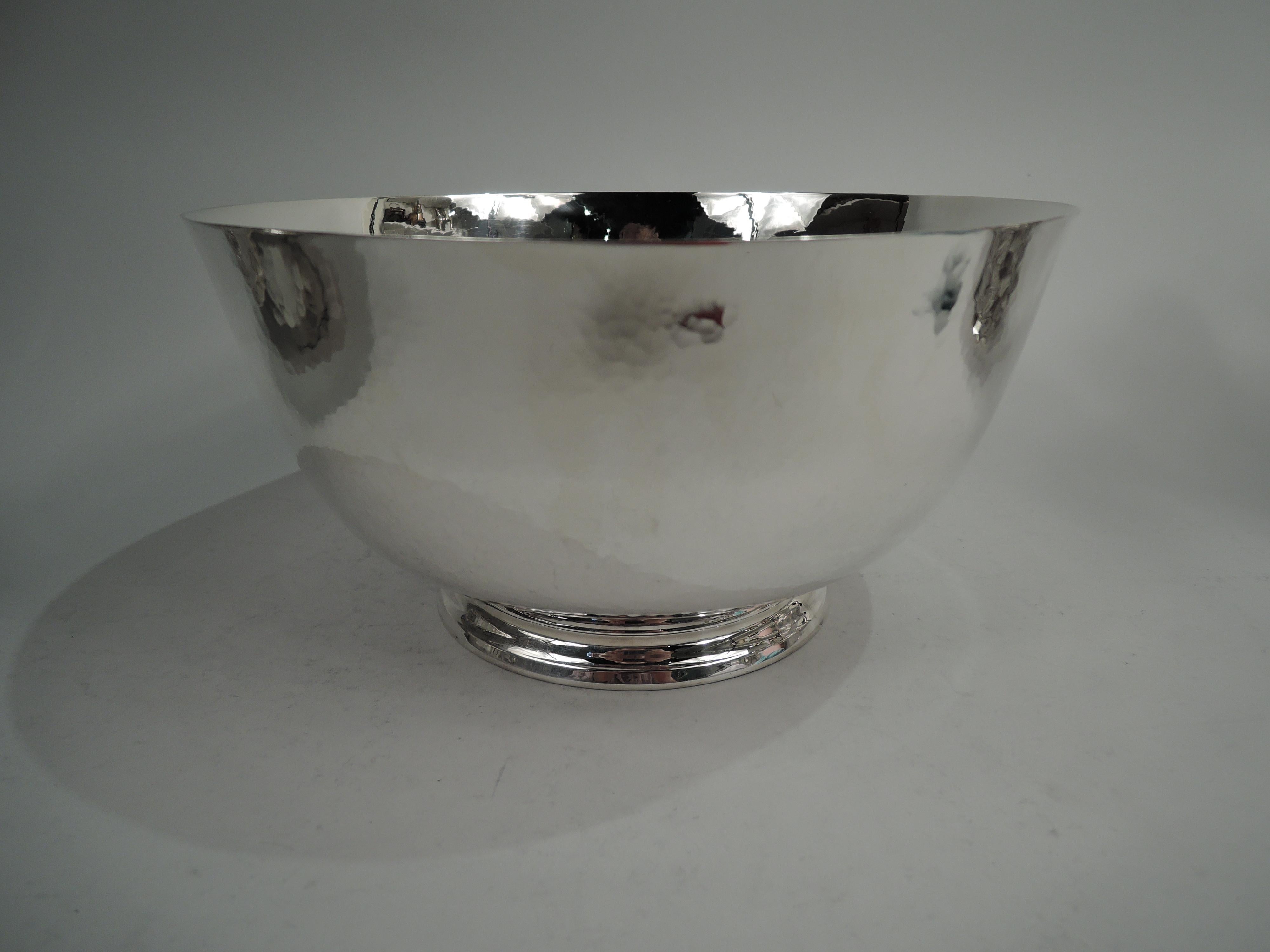 Large sterling silver Revere bowl, ca 1930. Retailed by Cartier in New York. Traditional form with tapering sides, curved bottom; allover spot hammering. Plain and stepped foot. Fully marked including maker’s (Old Newbury Crafters) and retailer’s