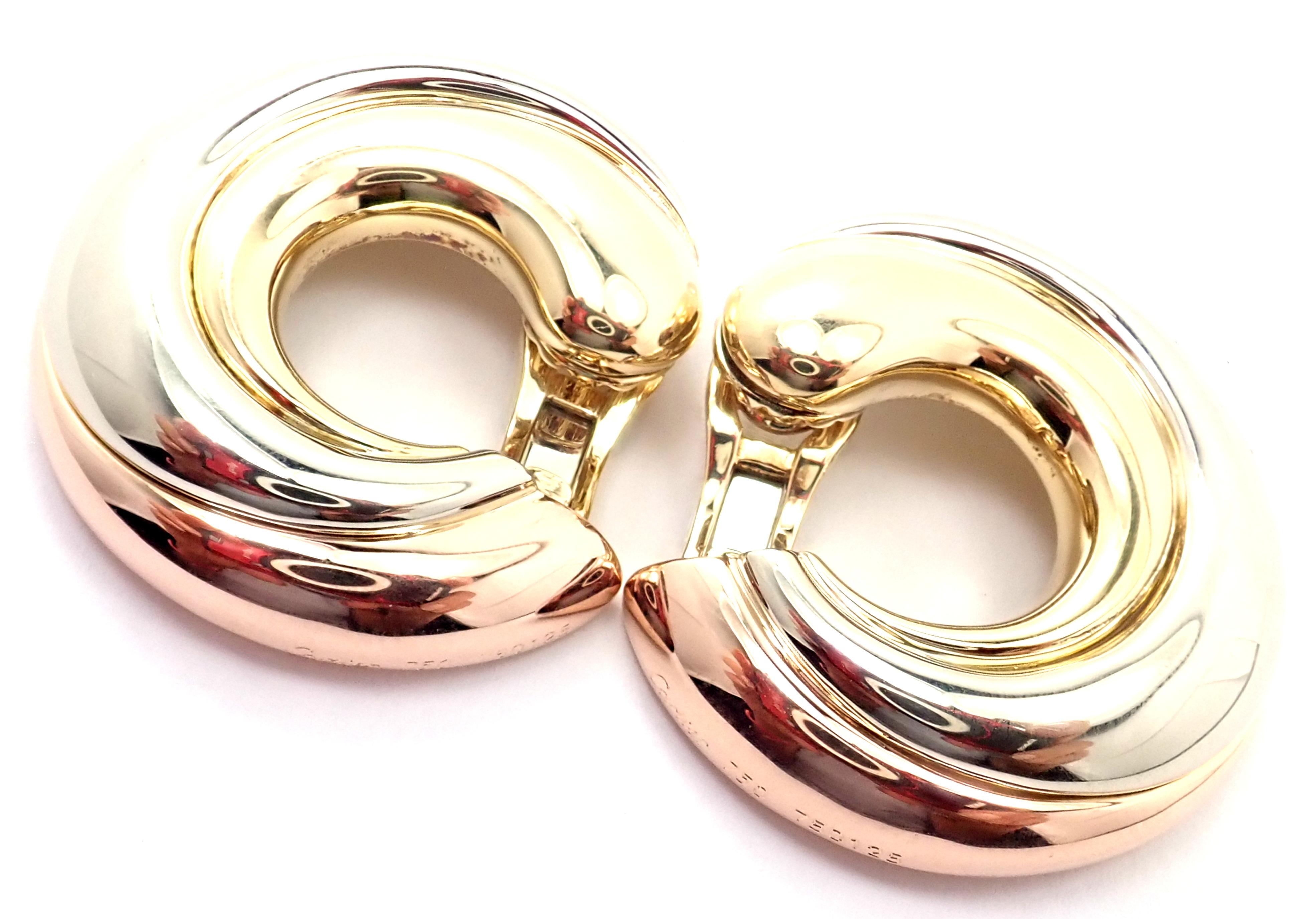 18k Tri-Color (Yellow, White, Rose) Gold Large Size Trinity Hoop Earrings by Cartier.  
These earrings are for non pierced ears but they can be converted by adding posts.
Details:  
Measurements: 32mm
Weight: 28.2 grams
Stamped Hallmarks: Cartier