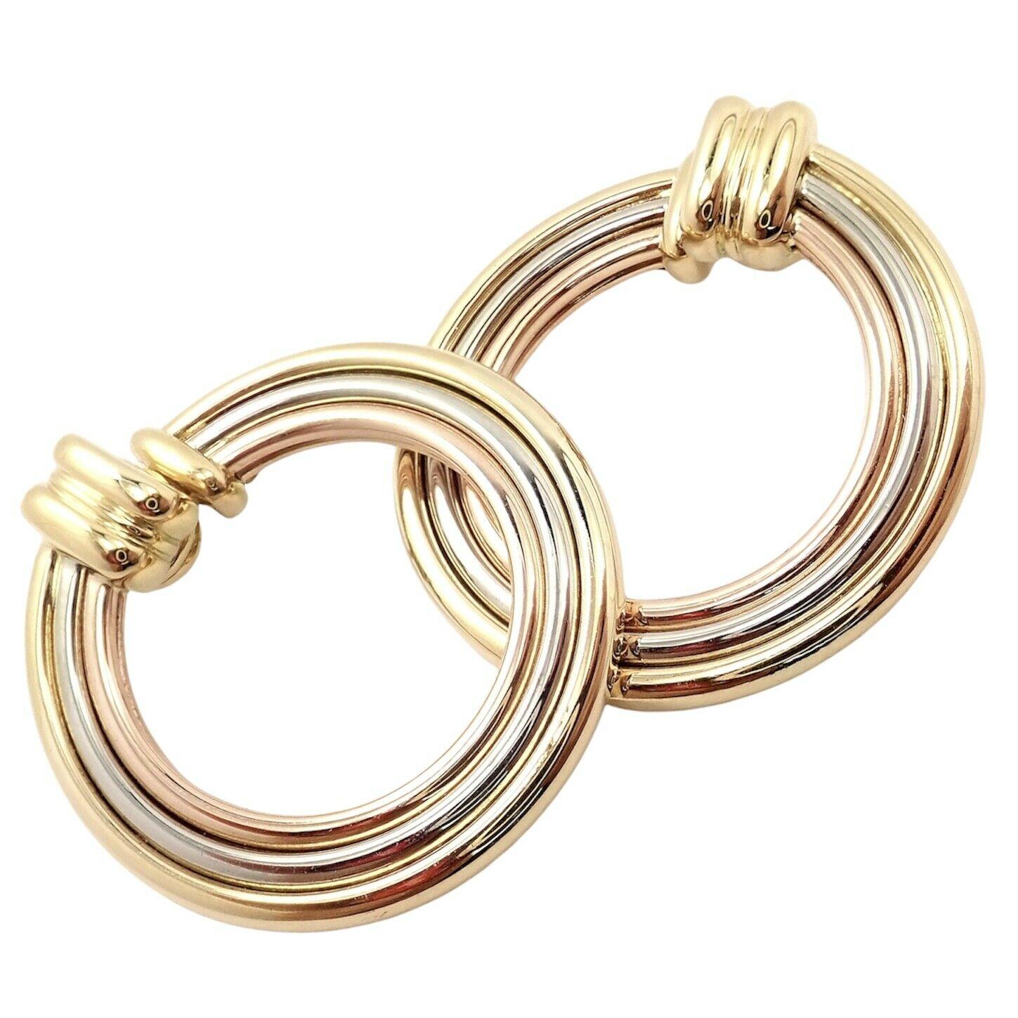 18k Tri-Color (Yellow, White, Rose) Gold Large Trinity Hoop Earrings by Cartier. 
These earrings are for pierced ears.
Details: 
Measurements: 30mm x 31mm
Weight: 15.4 grams
Stamped Hallmarks: Cartier 750 779XXX (serial number omitted)
*Free