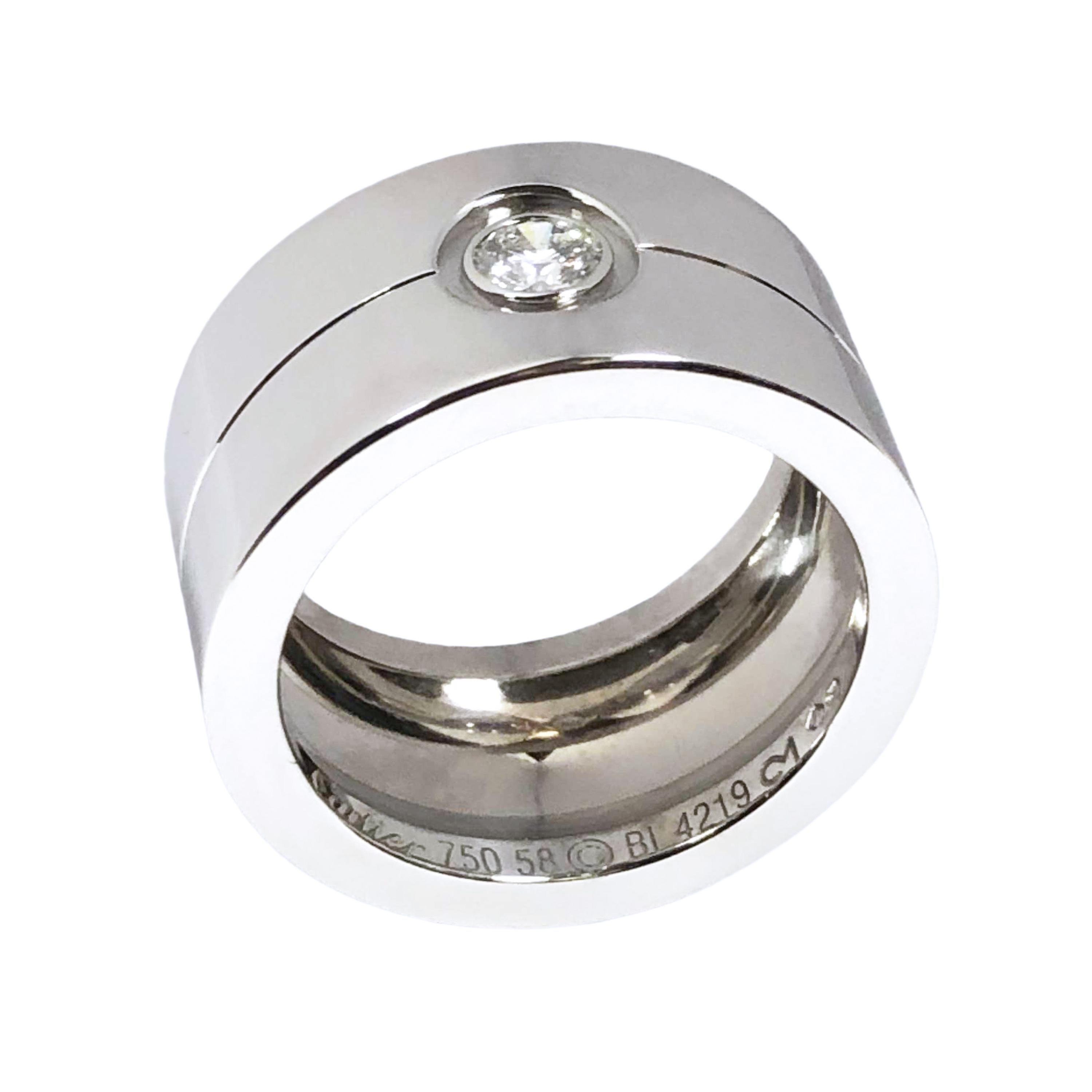 Circa 2010 Cartier 18K White Gold Wide Love Band Ring, this ring is from a very limited collection and are hard to find. Measuring 1/2 inch wide and 2 MM thick, centrally set with a 1/4 carat Round brilliant cut Diamond. Finger size 8 1/2 ( 58