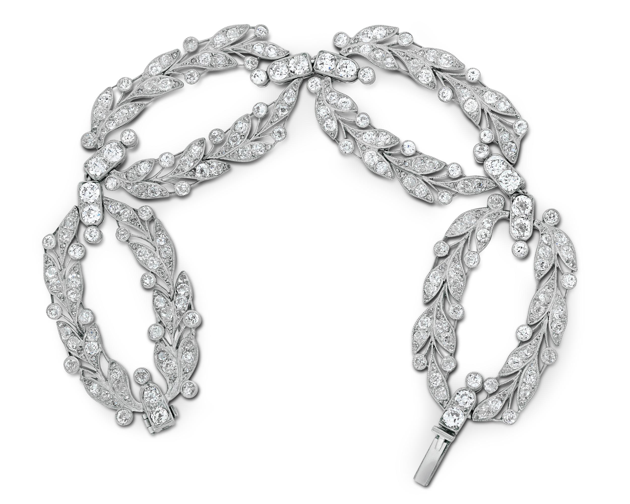 This delicate and enchanting laurel wreath bracelet hails from the esteemed firm Cartier Paris. Composed of four open oval links in a fine foliate design, the bracelet features millegrain-set Old European-cut and Old Mine-cut white diamonds. The