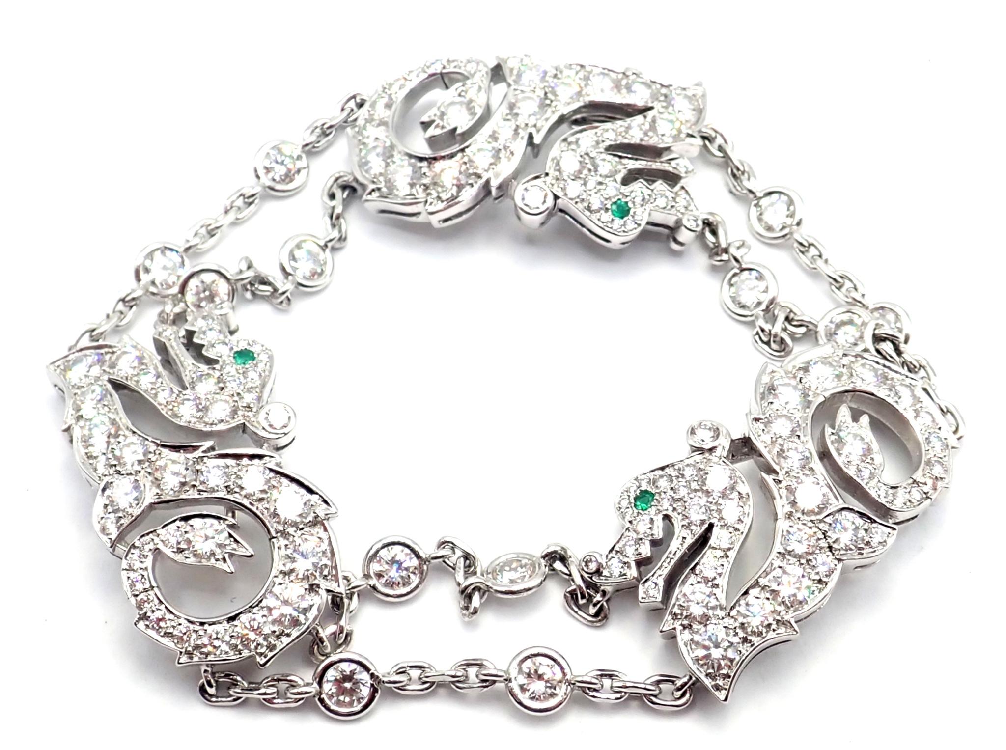 18k White Gold Diamond And Emerald Le Baiser Du Dragon Bracelet by Cartier. Ladies iconic Cartier bracelet featuring 3 dragons in 18k white gold. This bracelet features 3 dragons set with diamonds and green emeralds in the eyes. The dragons are