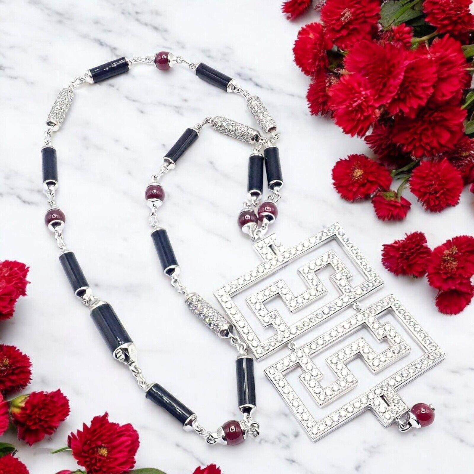 18k White Gold Diamond, Ruby, Onyx Link Chain Pendant Necklace by Cartier. Part of the Cartier Le Baiser Du Dragon Collection. 
The Cartier Le Baiser Du Dragon Pendant Necklace is an exquisite piece, featuring a striking design in 18k white gold.