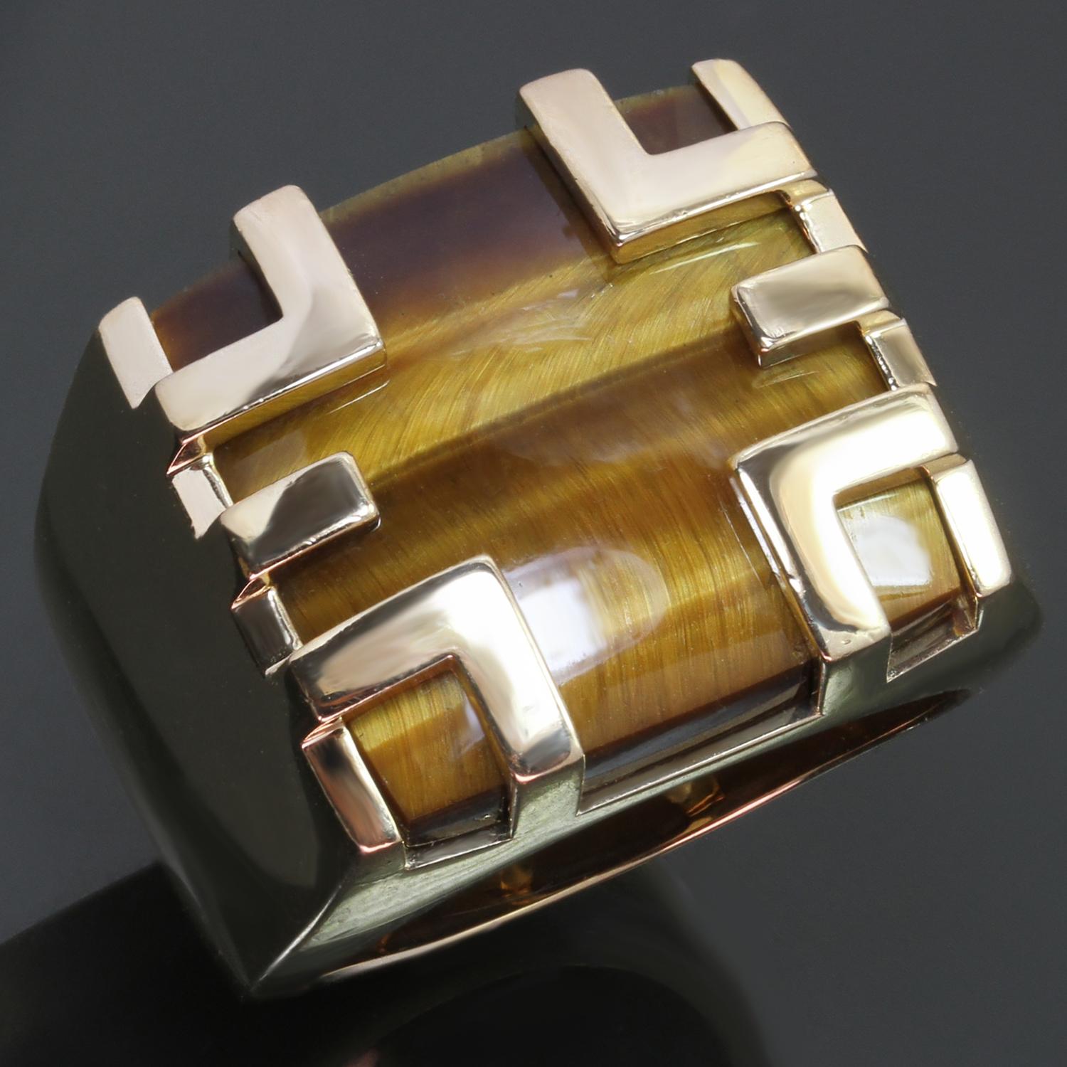 This exquisite vintage authentic Cartier cage ring from the classic Le Baiser Du Dragon is crafted in 18k yellow gold and set with a cushion-cut Tiger's Eye. Signed Cartier 750 and numbered. Made in France circa 1970s. Measurements: 0.78