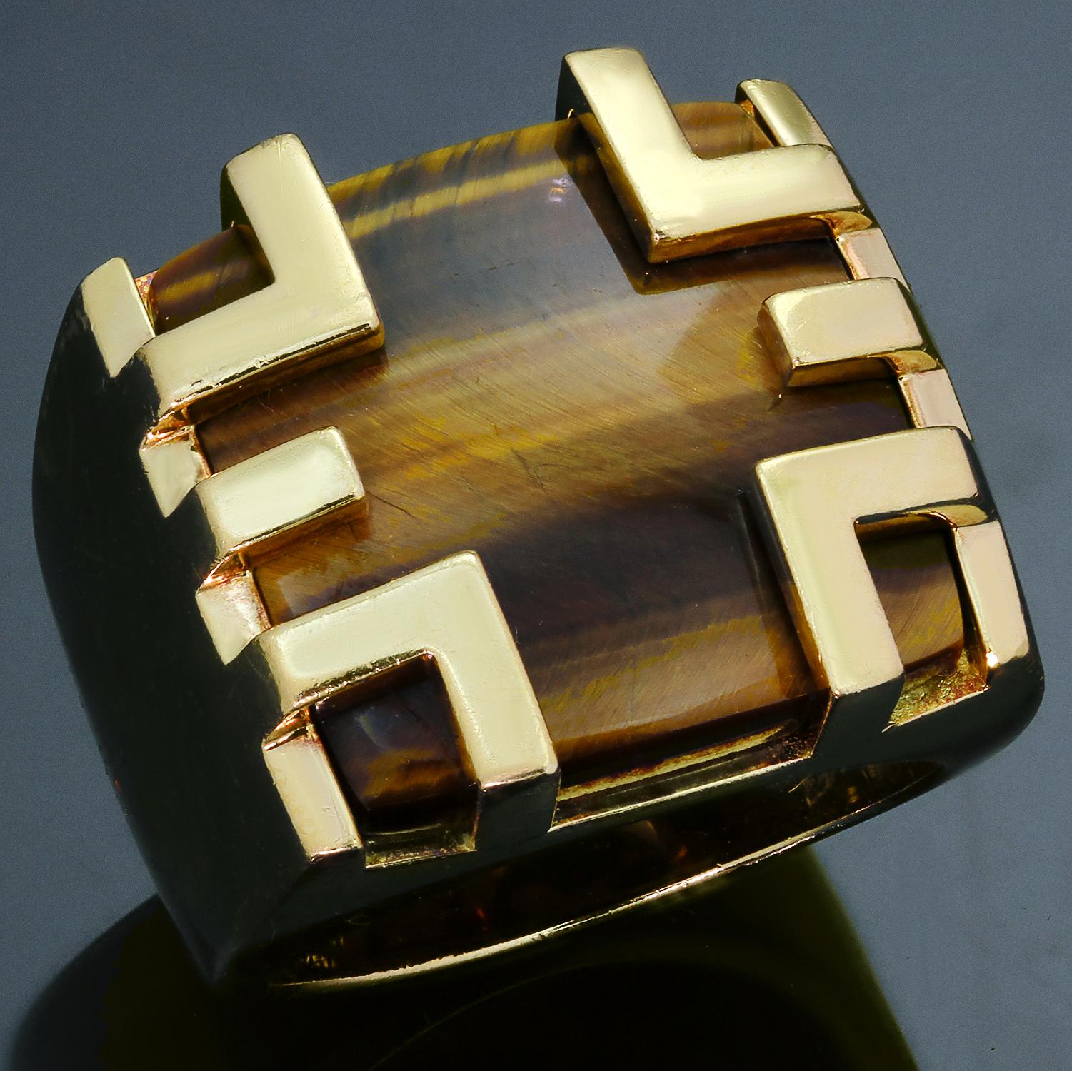 This exquisite Cartier cage ring from the classic Le Baiser Du Dragon is crafted in 18k yellow gold and set with a cushion-cut Tiger's Eye. Signed Cartier 750 and numbered. Made in France circa 1970s. Measurements: 0.90