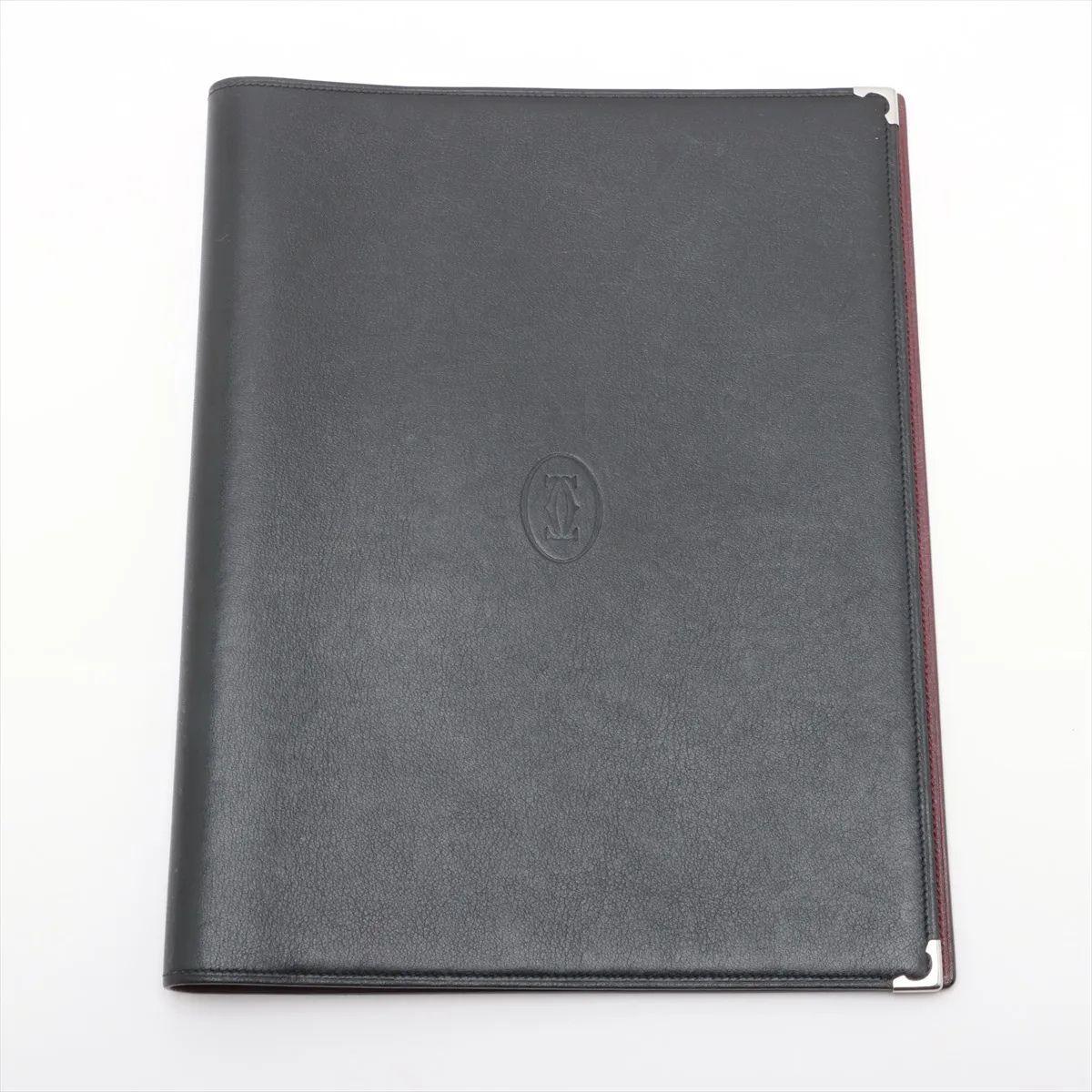 Das Cartier Leder Notebook Cover in Schwarz ist der Inbegriff klassischer Eleganz und raffinierter Handwerkskunst. Sie ist aus glattem, vollnarbigem schwarzem Leder gefertigt und bietet Ihrem Notebook einen luxuriösen Schutz, ohne seine schlanke