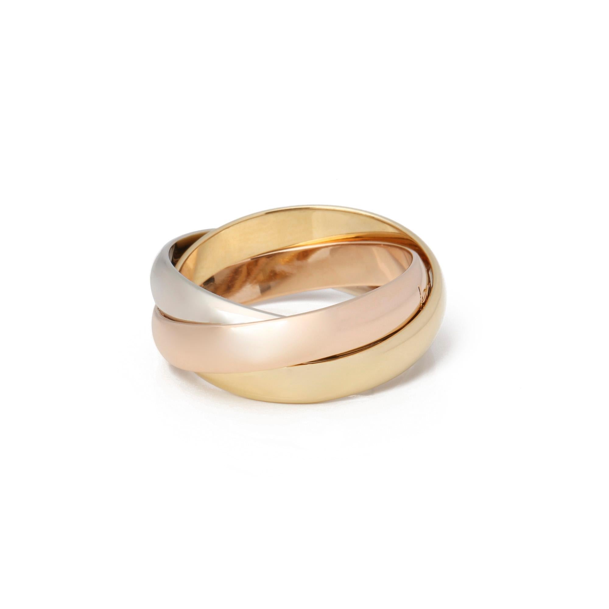 This ring by Cartier is from their Les Must De Cartier Trinity collection and features 18k yellow, white and rose gold interlinking bands. UK ring size K. EU ring size 50. US ring size 5 1/2. This ring cannot be re sized. Complete with a Xupes