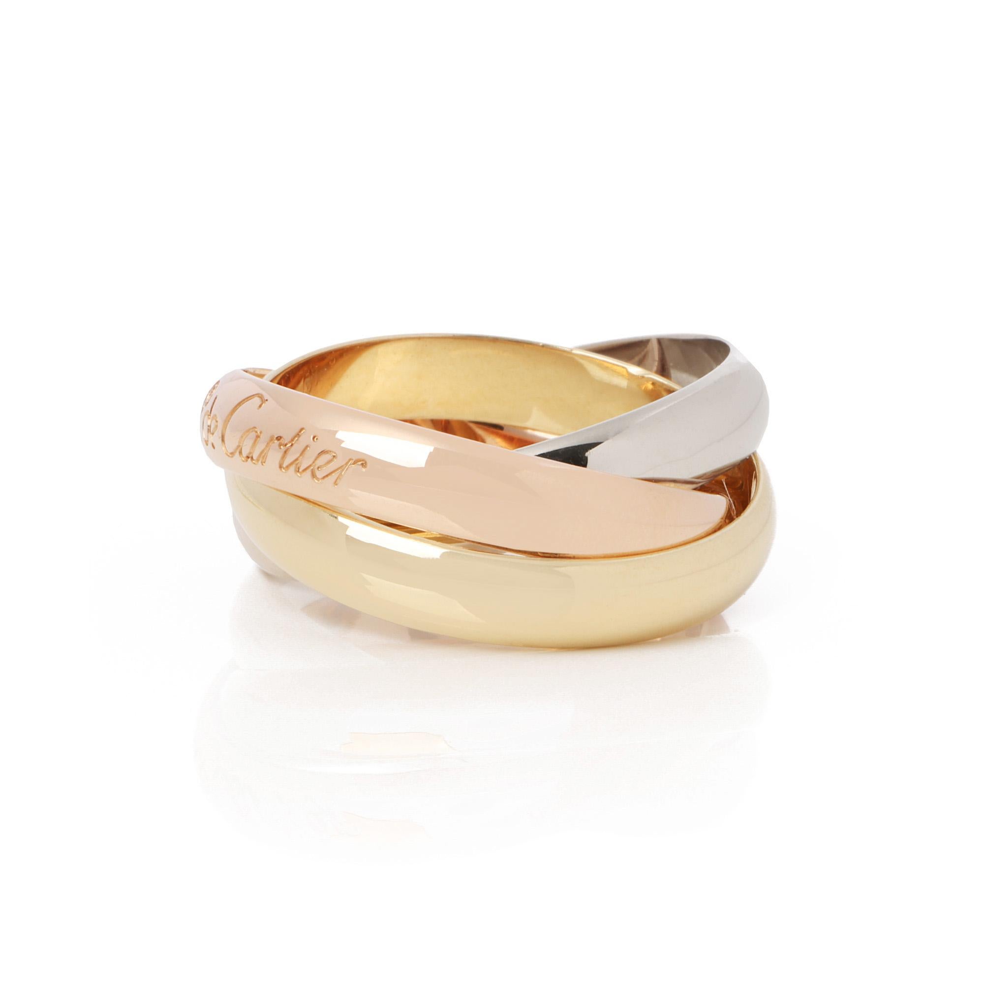 This ring by Cartier is from their Trinity collection and features 18k yellow, white and rose gold interlinking bands. UK ring size K 1/2. EU ring size 51. US ring size 6. This ring cannot be resized. Complete with a Xupes presentation box. Our