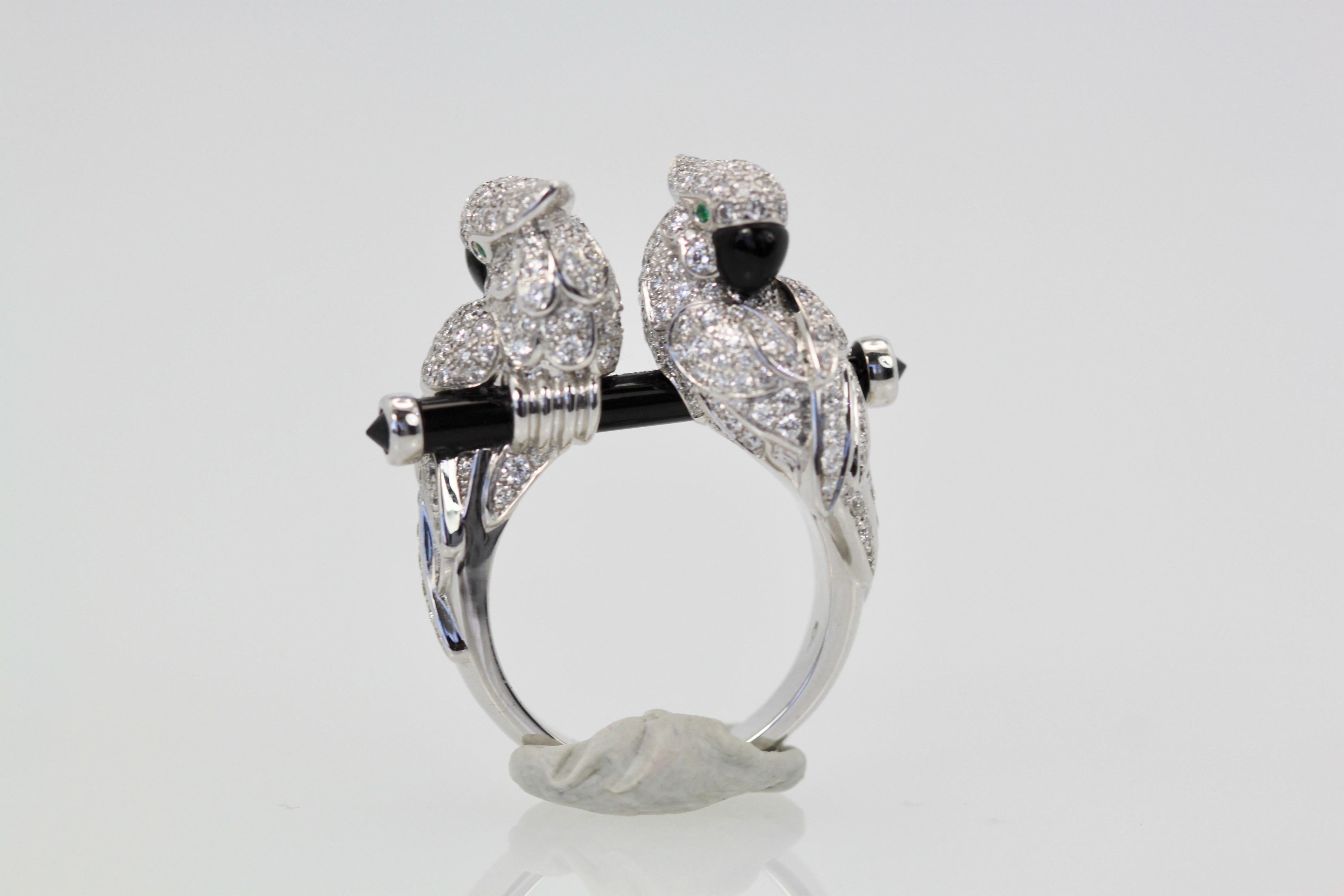 This ring from Cartier is rare and highly coveted.  It is from the Les Oiseau Liberes collection which includes pendant, bracelet and earrings which are extremely hard to find, as was this piece.  These parrots are sitting on an onyx branch doted on