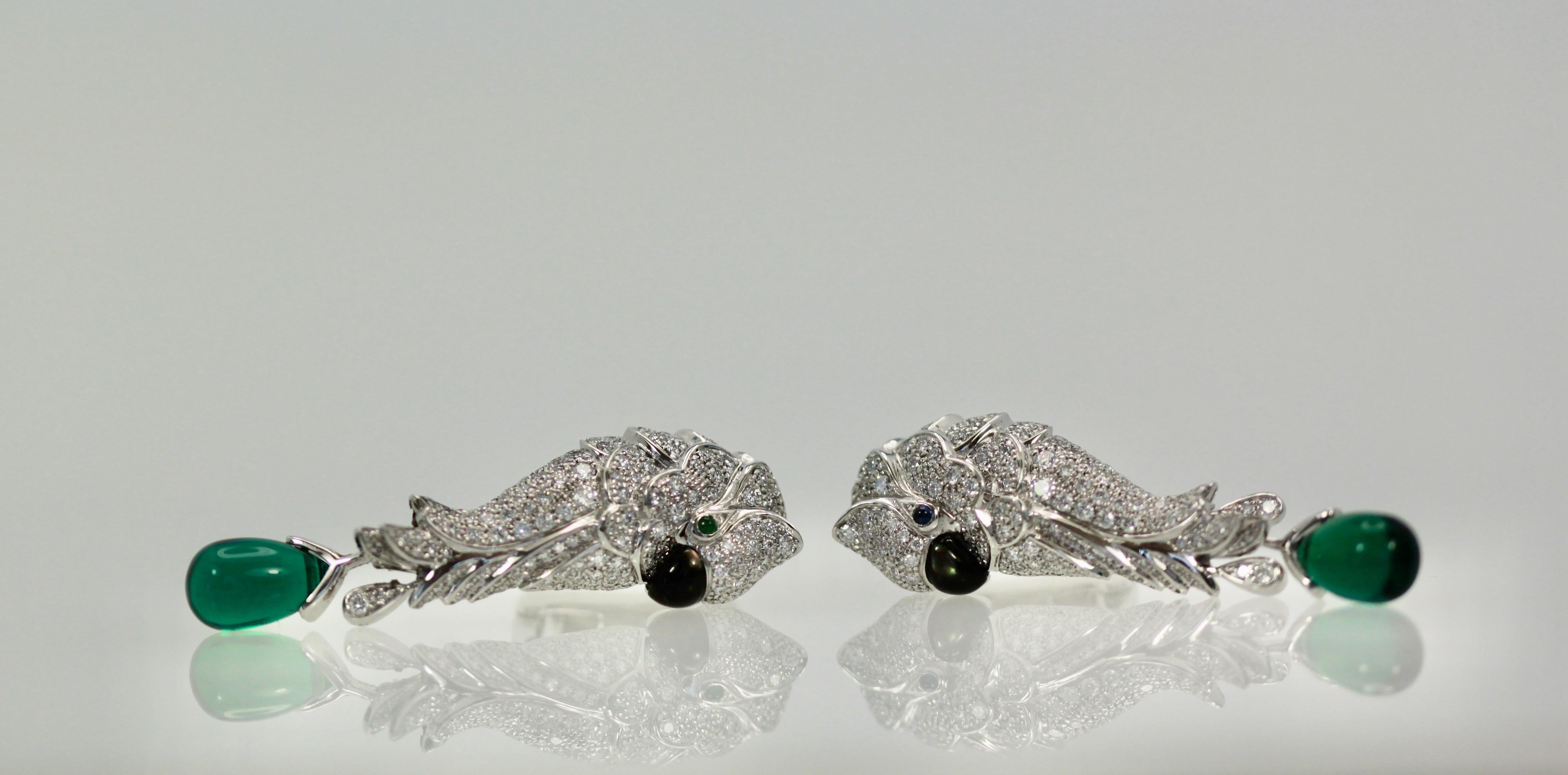 These gorgeous Cartier Earrings are designed as a Parrot all in Diamonds with one Emerald eye, one Sapphire eye an Onyx beak and an Emerald drop.  They measure 40cm in length, 30cm without Emerald drop.  There are 186 Brilliant round Diamonds F-G,