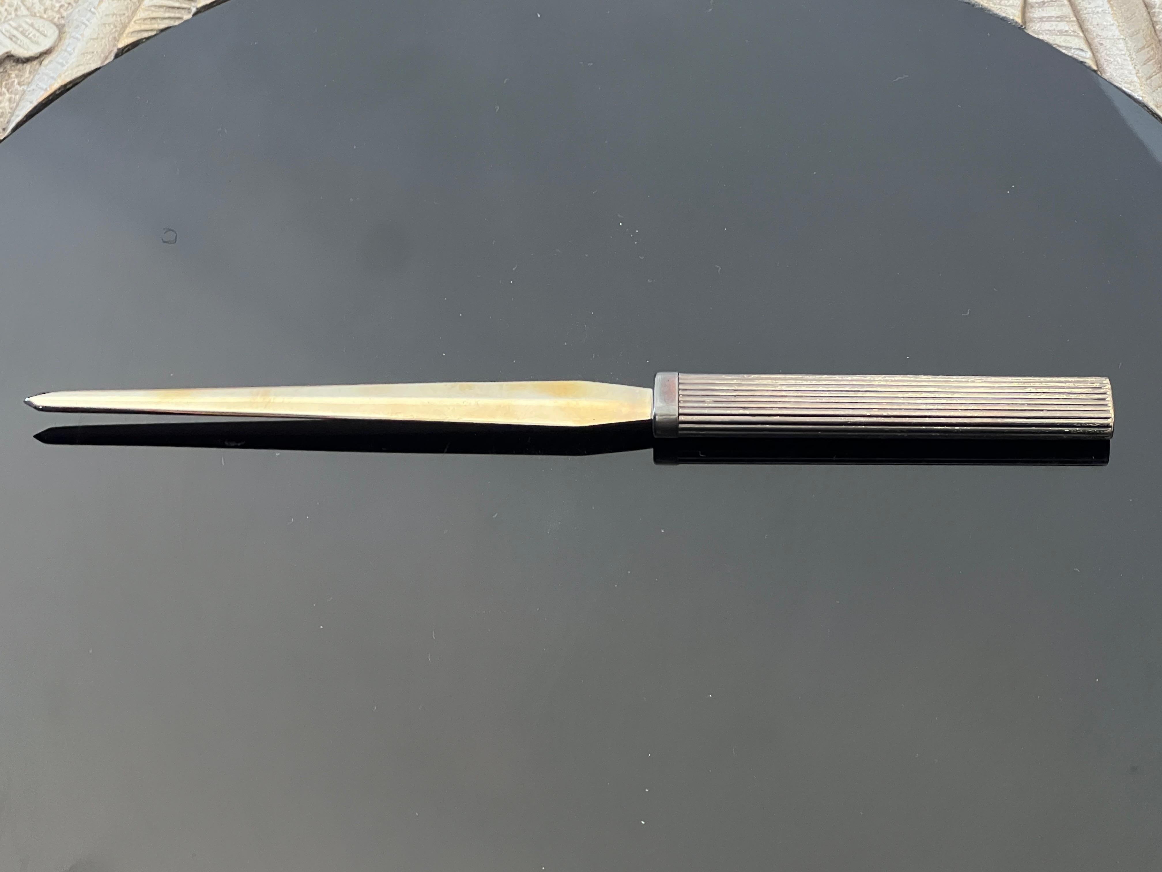 An elegant letter opener by Cartier ca' 1970's. Sterling handle, made in Italy, original box and wrapping.