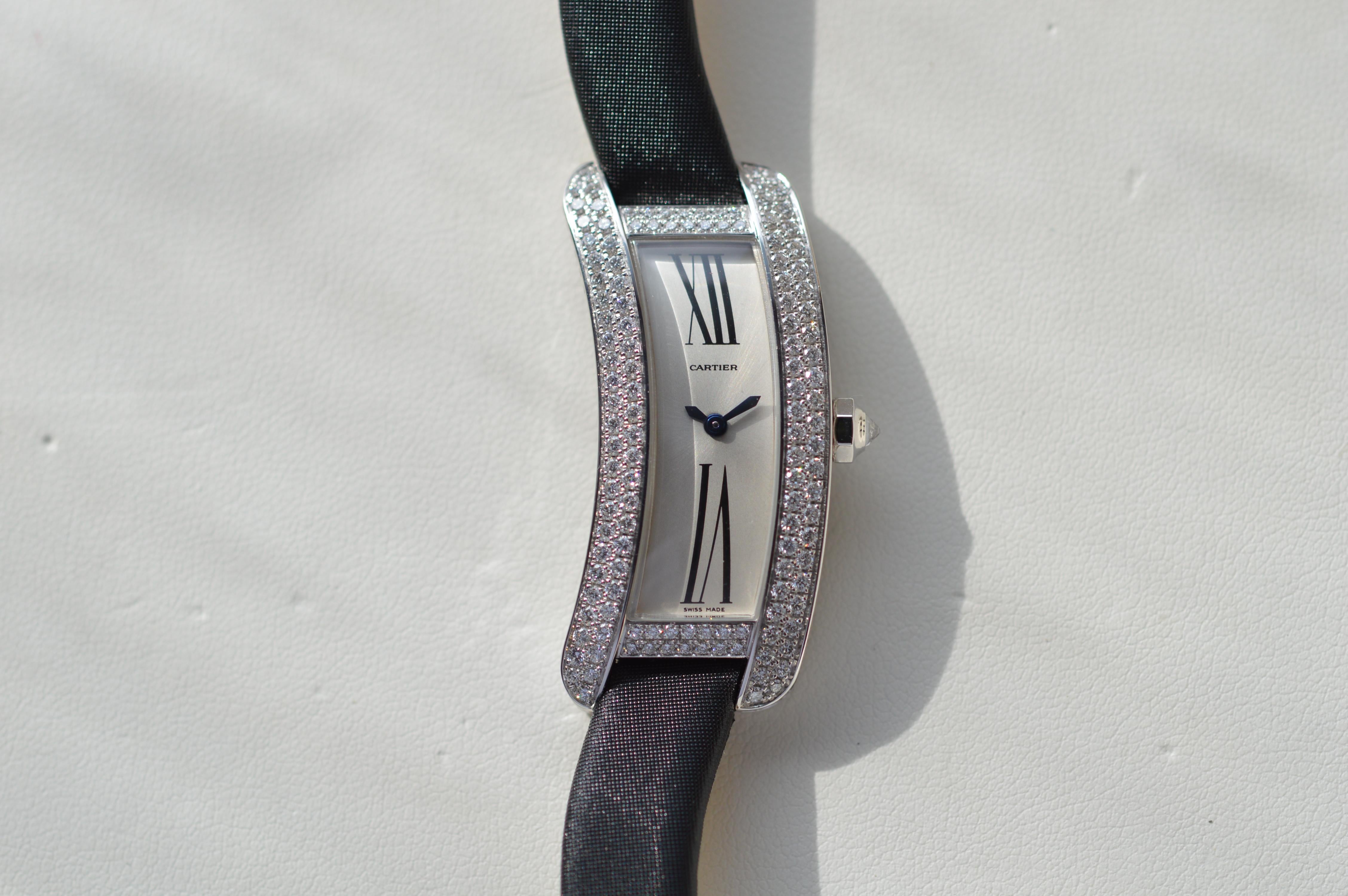 Cartier Libre Tank S Curved in 18K White Gold with Satin Strap
From the Cartier Libre Collection
Reference n° WJ300950
40mm X 13mm Size
18K White Gold Case
Black Satin Strap
Diamond Crown
Diamond Buckle
Diamond Case
325 Top Wesselton Diamonds for a