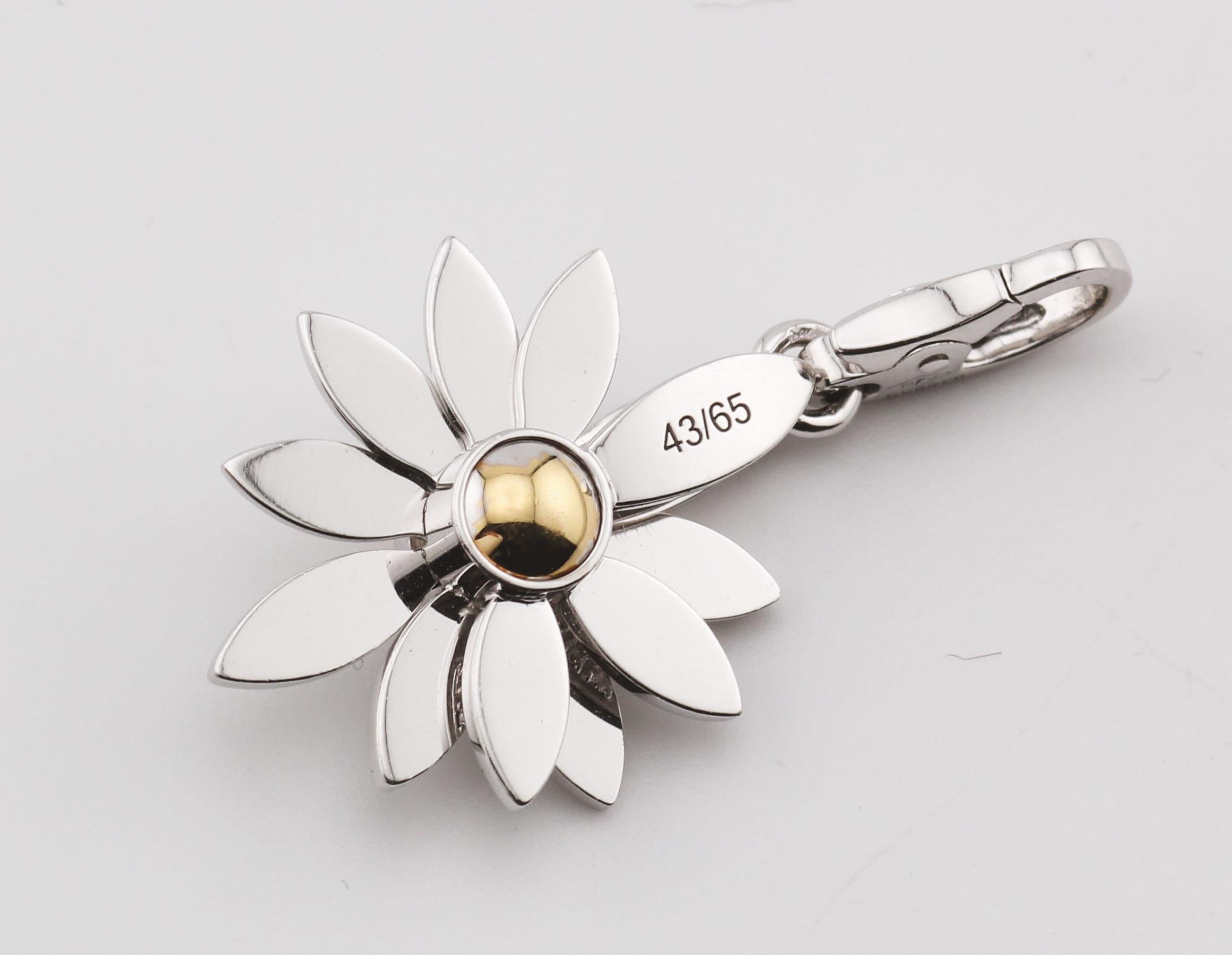 A whimsical and romantic masterpiece, the Cartier Limited Edition 18K Gold White and Yellow Diamond Daisy Charm Pendant is a captivating blend of luxury, artistry, and sentiment. This exquisite floral charm features an ingenious design with folding