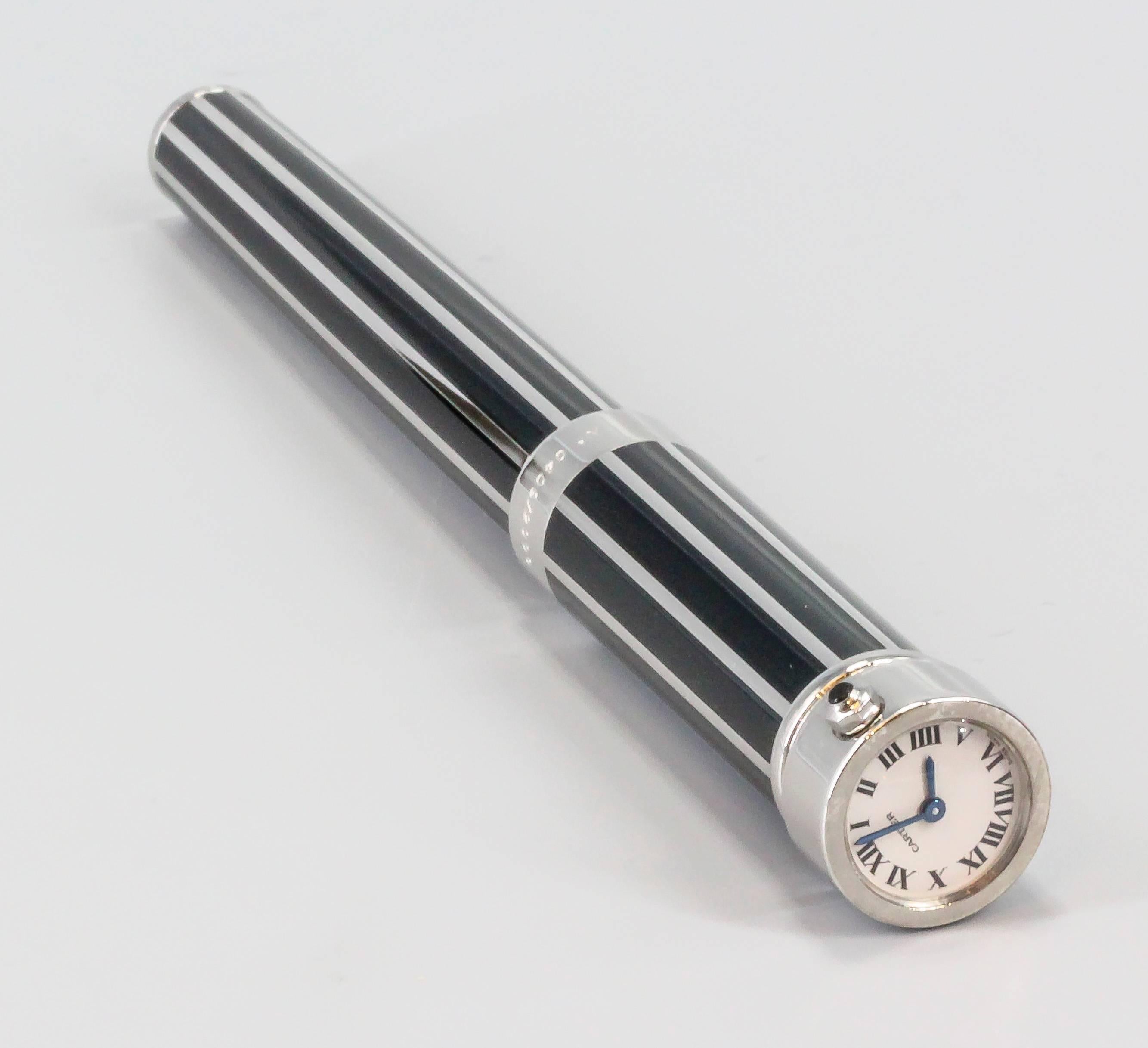 Handsome limited edition ( 2000 made) clock/watch fountain pen by Cartier. It features screw cap pen with a small quartz movement watch at the very top, with roman numerals. Comes with original Cartier box and limited edition certification paper,