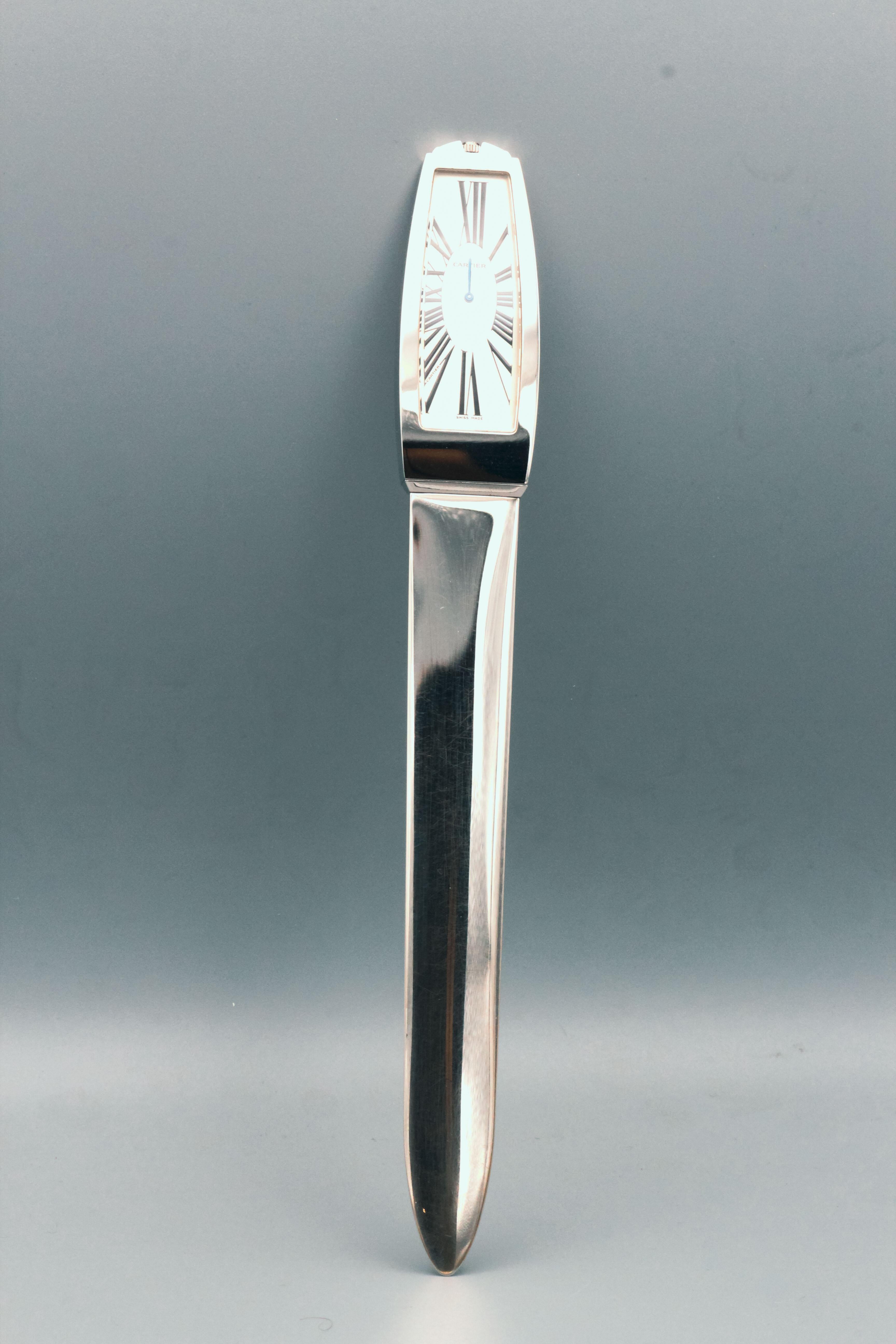 Handsome limited edition (#0371 of 2000 made) clock/letter opener by Cartier. It features a large clock at the end of it, with a quartz movement and roman numerals. Comes with pouch. Beautifully made and would make a great gift.

Hallmarks: Cartier,