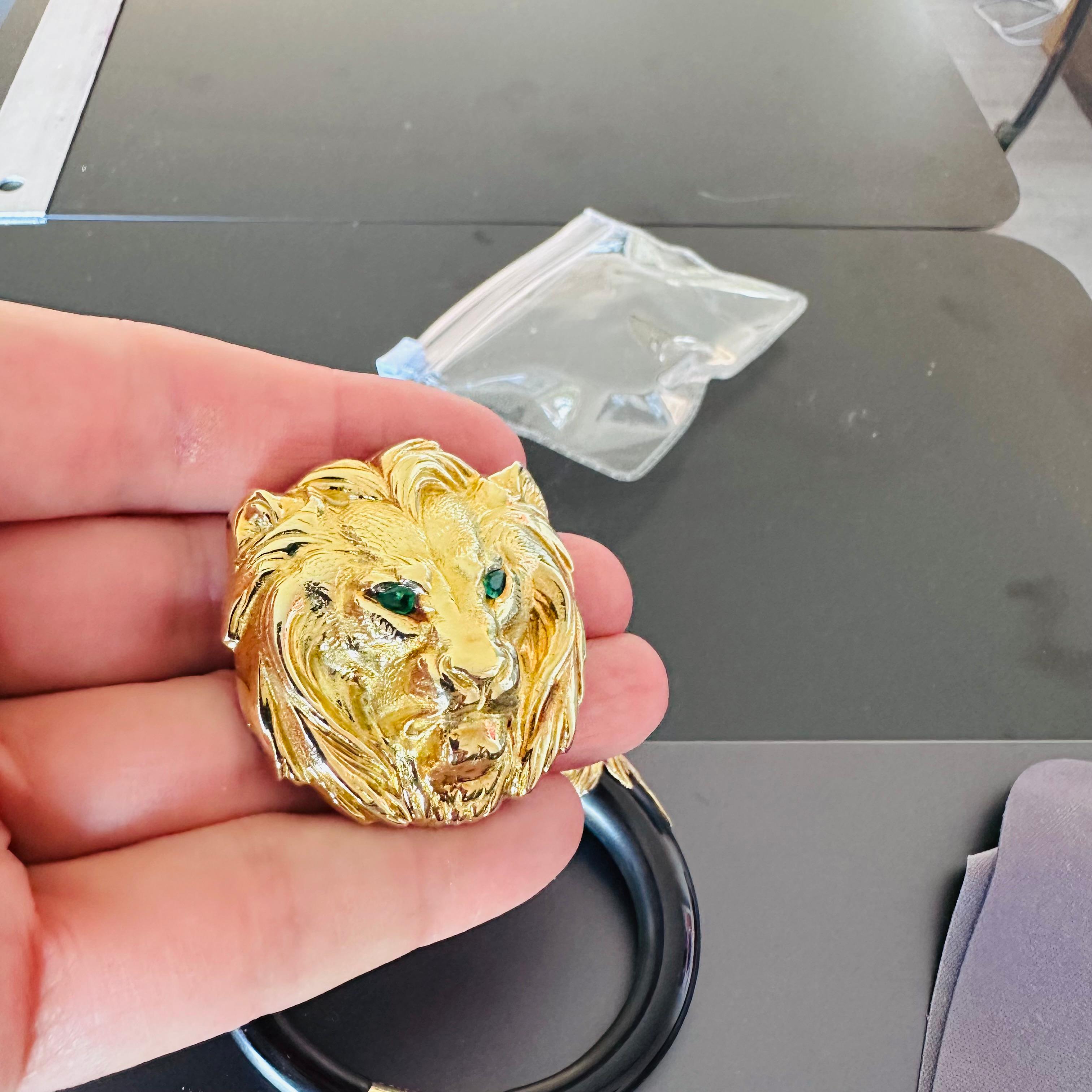 Cartier, 18 karat yellow gold lions head with green emerald eyes. Worn either as a Pendant or a Brooch  the condition is Fair the lion has been polished over the years and the condition is fair, although original and very well loved the lion is