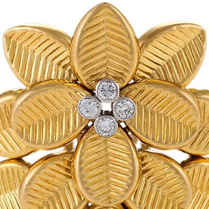 An English Mid-20th Century flower-shaped 18 karat gold brooch with diamonds by Cartier London. The brooch has 4 round diamonds with an approximate total weight of .28 carat. The  flower is composed of deeply engraved overlapping leaves leading to