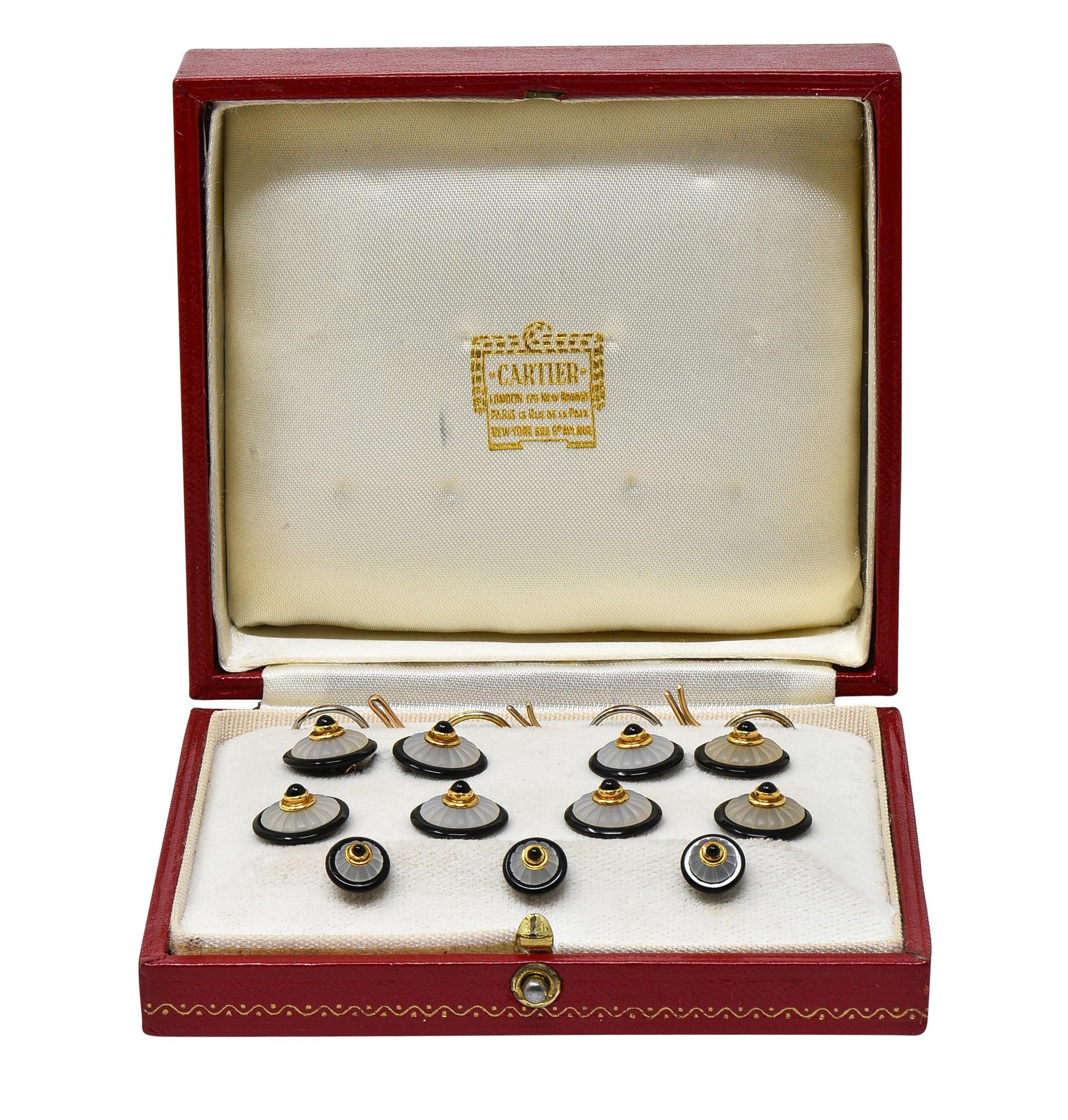 Designed as a full dress set, including bar and link cufflinks, shirt studs, and fasteners 
Comprised of matching round onyx disks centering 1.5 to 2.5 mm onyx cabochons
Set in gold bezels atop dome-shaped rock crystal quartz - carved with fluted