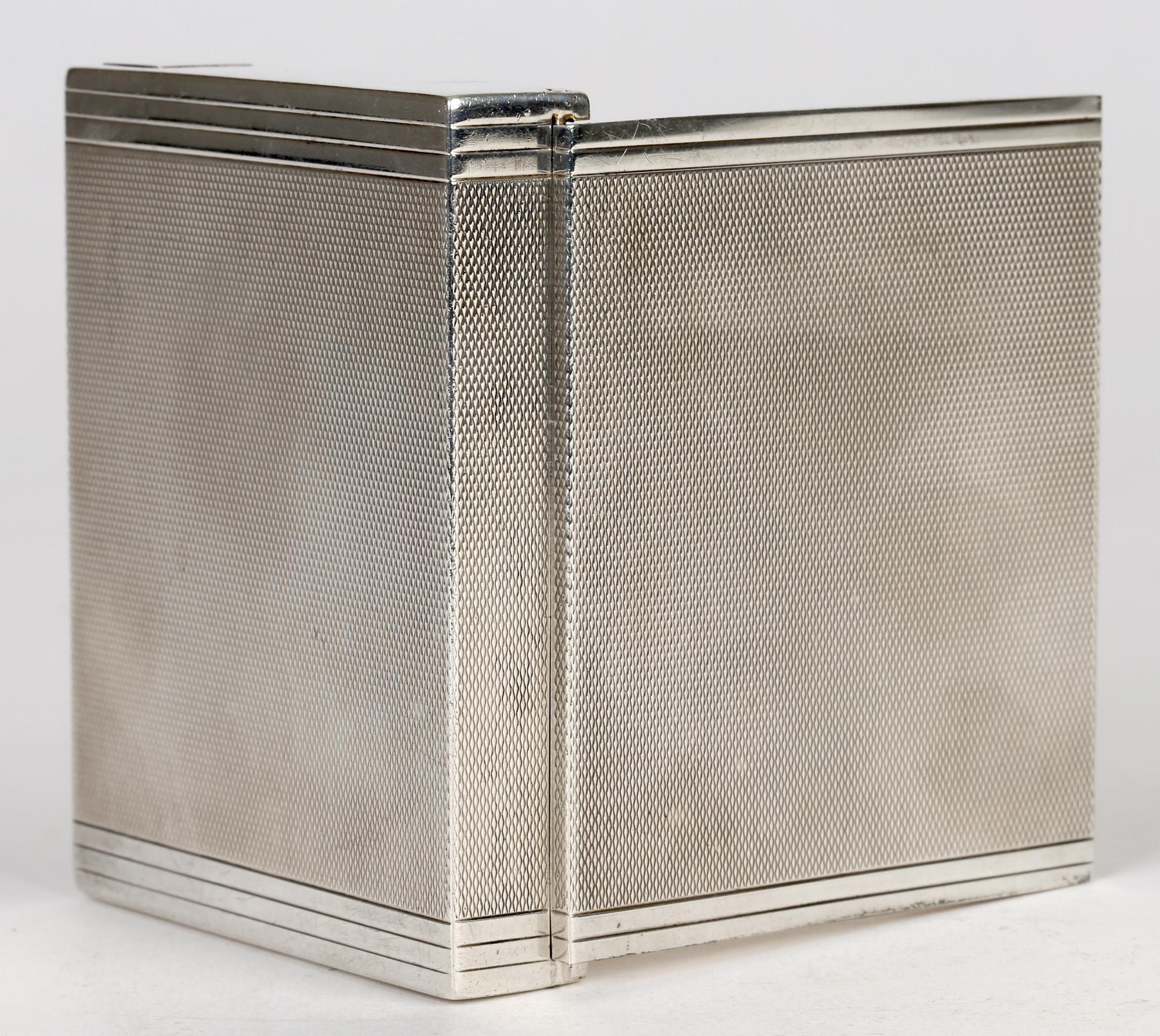 A very fine quality and heavily made vintage Art Deco Cartier silver cigarette or card case made in London in 1936. The rectangular card case has a simple linear design with an engine turned patterned body with square designs to the sides two of