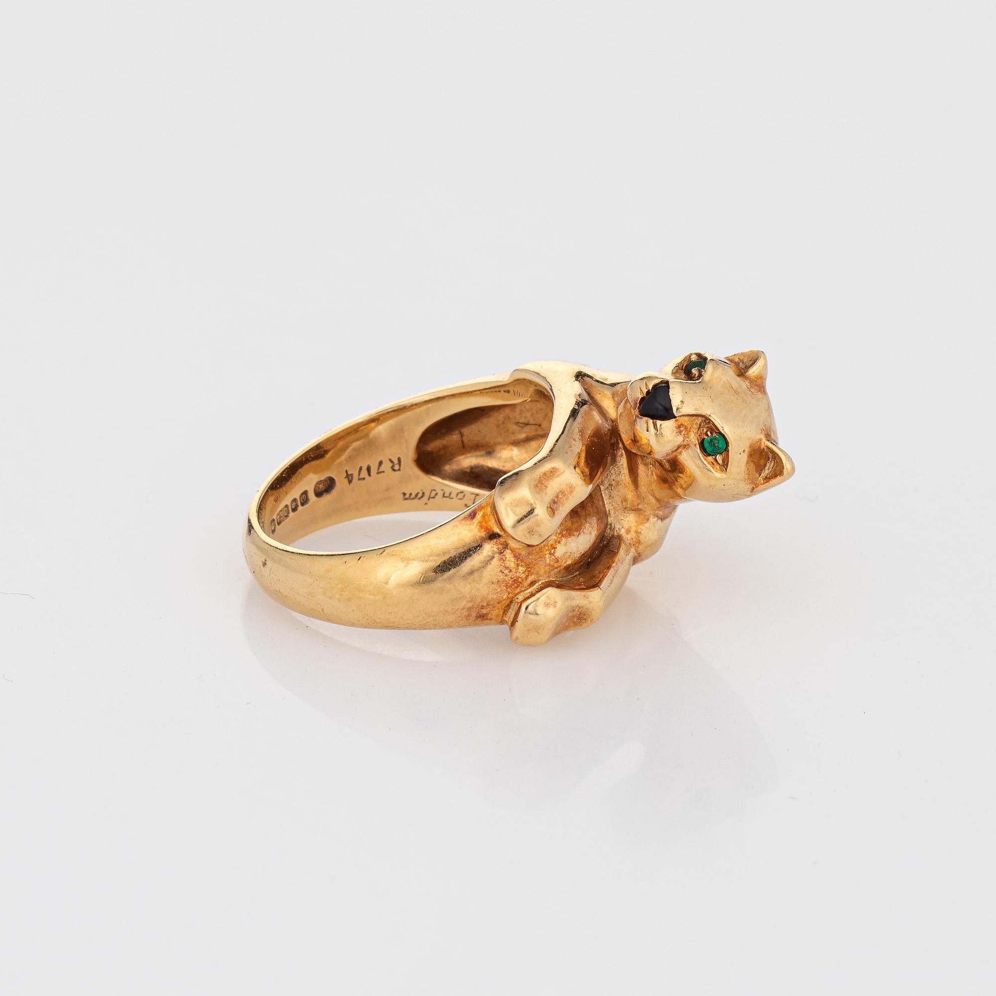 Vintage Cartier Panthere ring crafted in 18 karat yellow gold (circa 1988).  

Two estimated 0.02 carat emeralds are set into the eye, with a 2mm piece of onyx set into the nose.

The vintage Cartier Panthere ring was made by the Cartier London