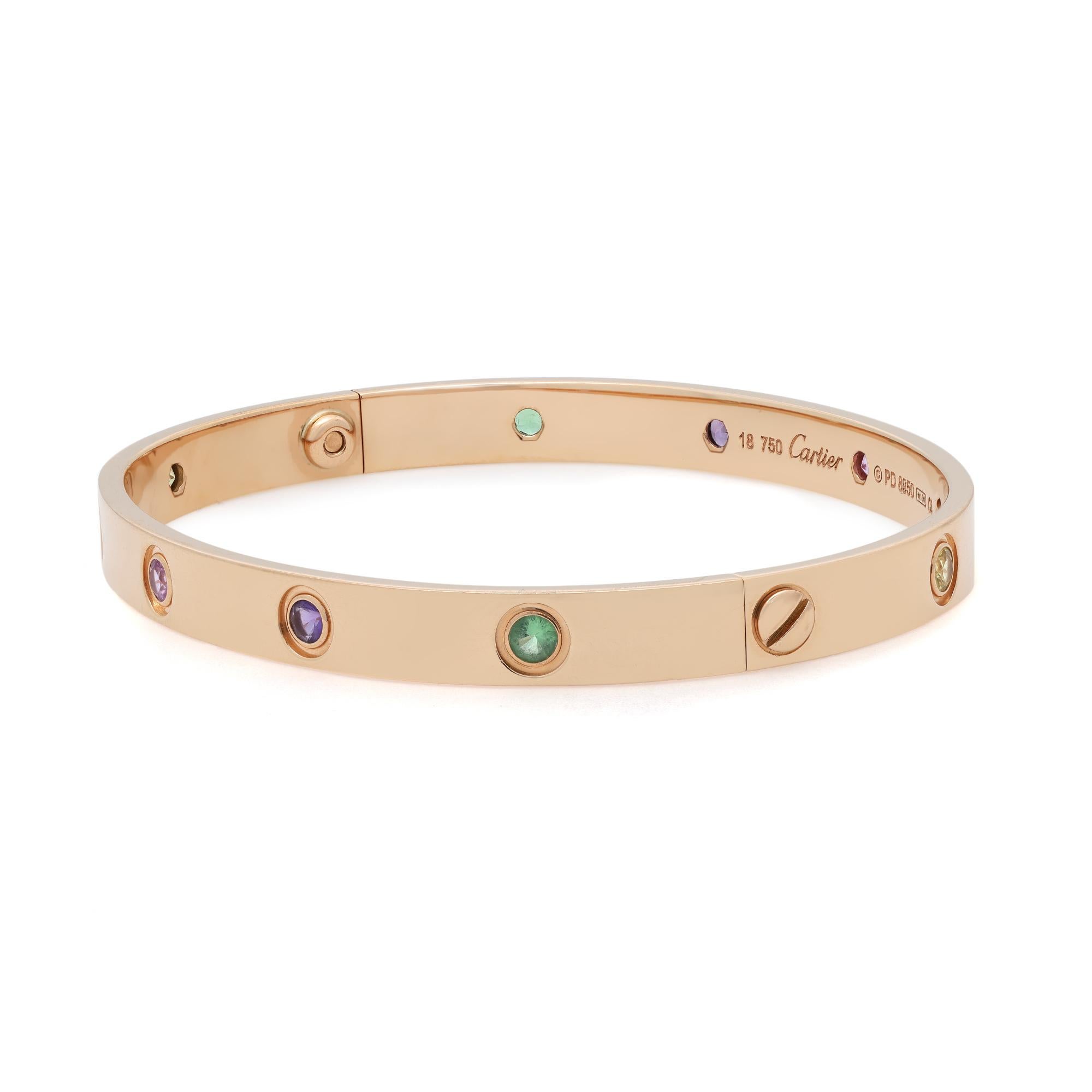 Cartier Love bracelet crafted in 18k rose gold, set with 10 round cut colored gemstones. Size: 18. Old screw style system. Width: 6.1 mm. Total weight: 29 grams. Great pre-owned condition. Will be polished before shipping. Comes with a screwdriver.