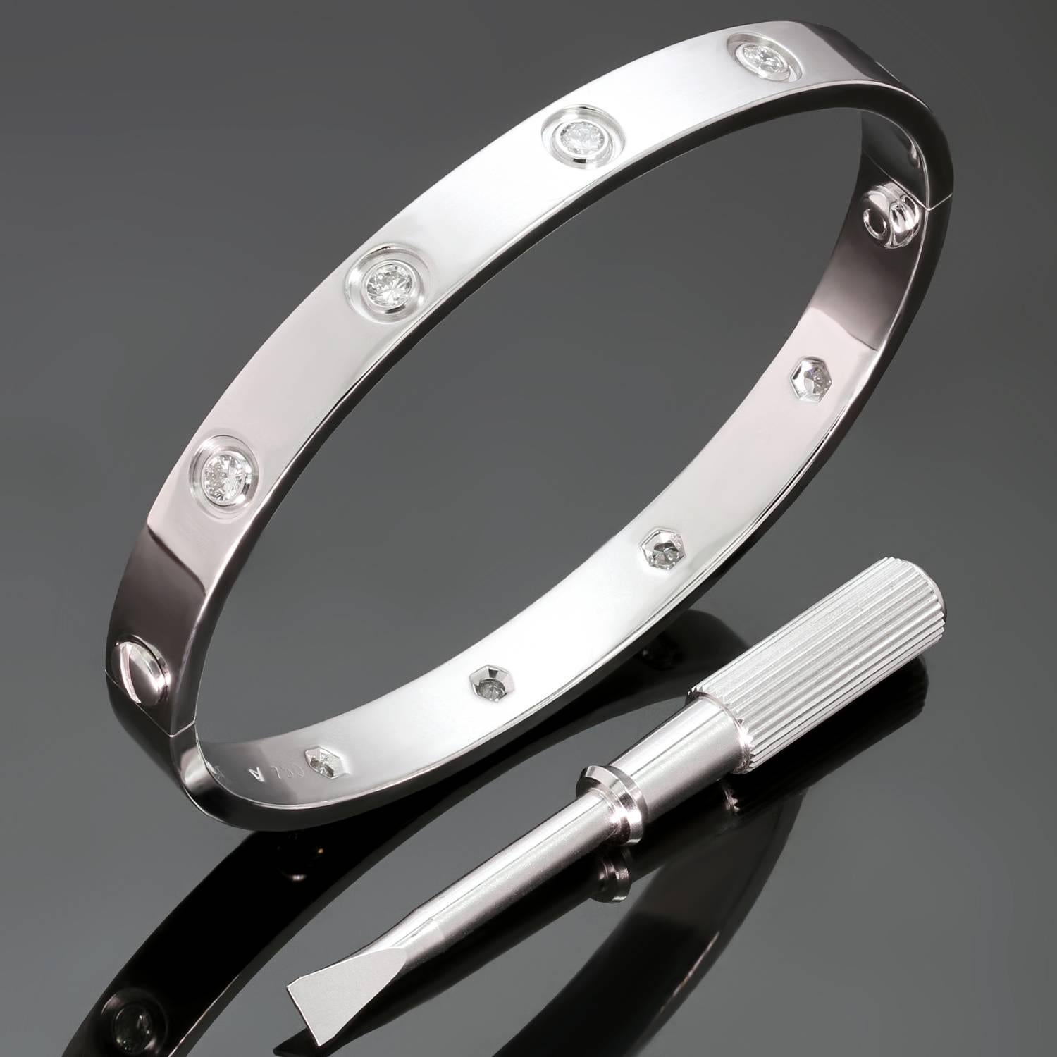 This iconic and timeless bracelet from Cartier's Love collection is finely crafted in 18k white gold and set with 10 brilliant-cut round diamonds. Completed with the original Cartier screwdriver. This bangle is a size 17. Made in France circa 1997.