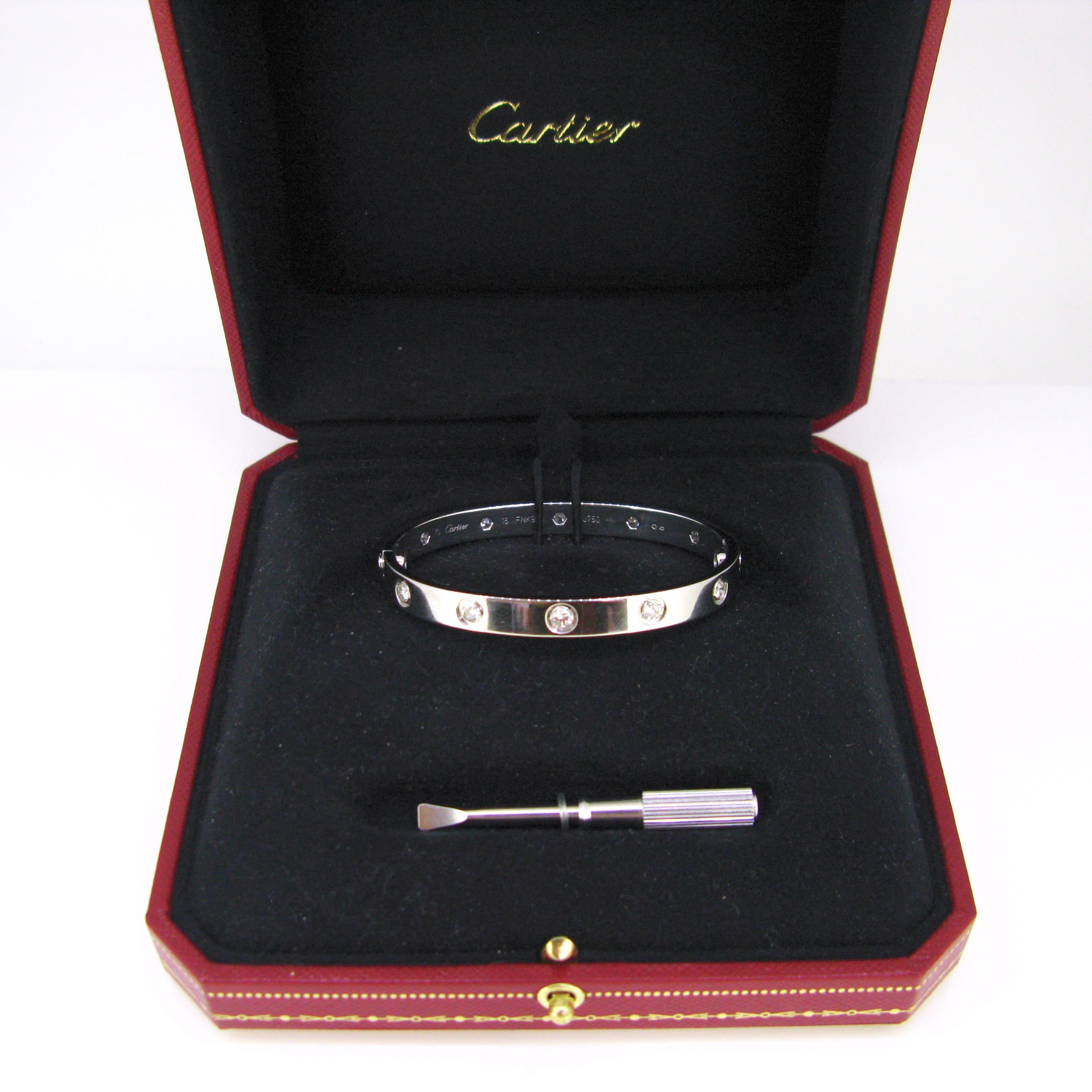 This beautiful Cartier Love Bangle is a size 16. It features 10 diamonds for a total carat weight of 1ct. It is made in 18kt white gold, signed Cartier and numbered FNK946. It comes with its original Cartier box. It is in great