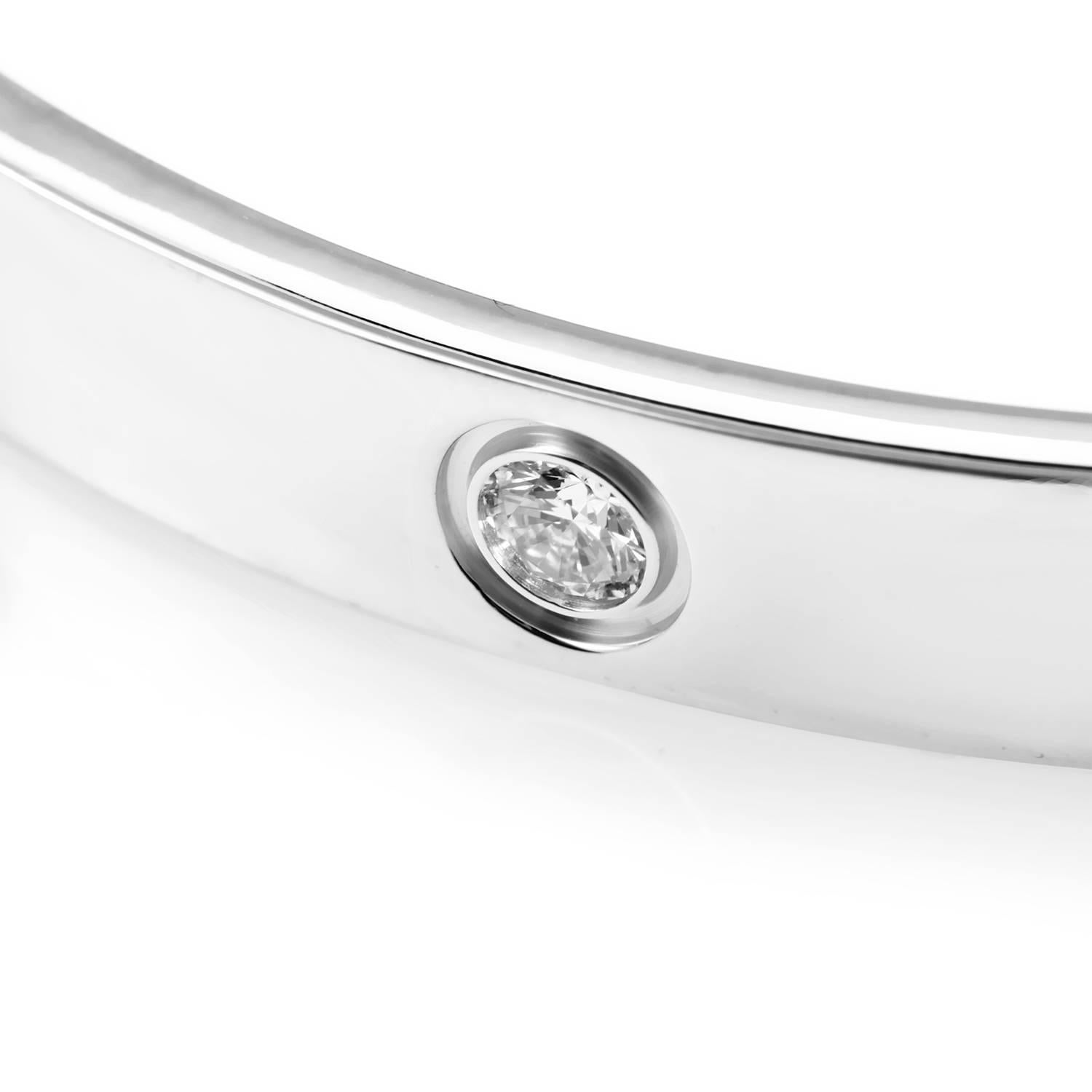 Cartier delivers a regal design in this 18K White Gold Bracelet. Evenly distributed diamonds alternate with the Cartier screw motif engraved in the precious metal's rotation. Lastly, a velvet bag provides safe haven to this gleaming treasure while a