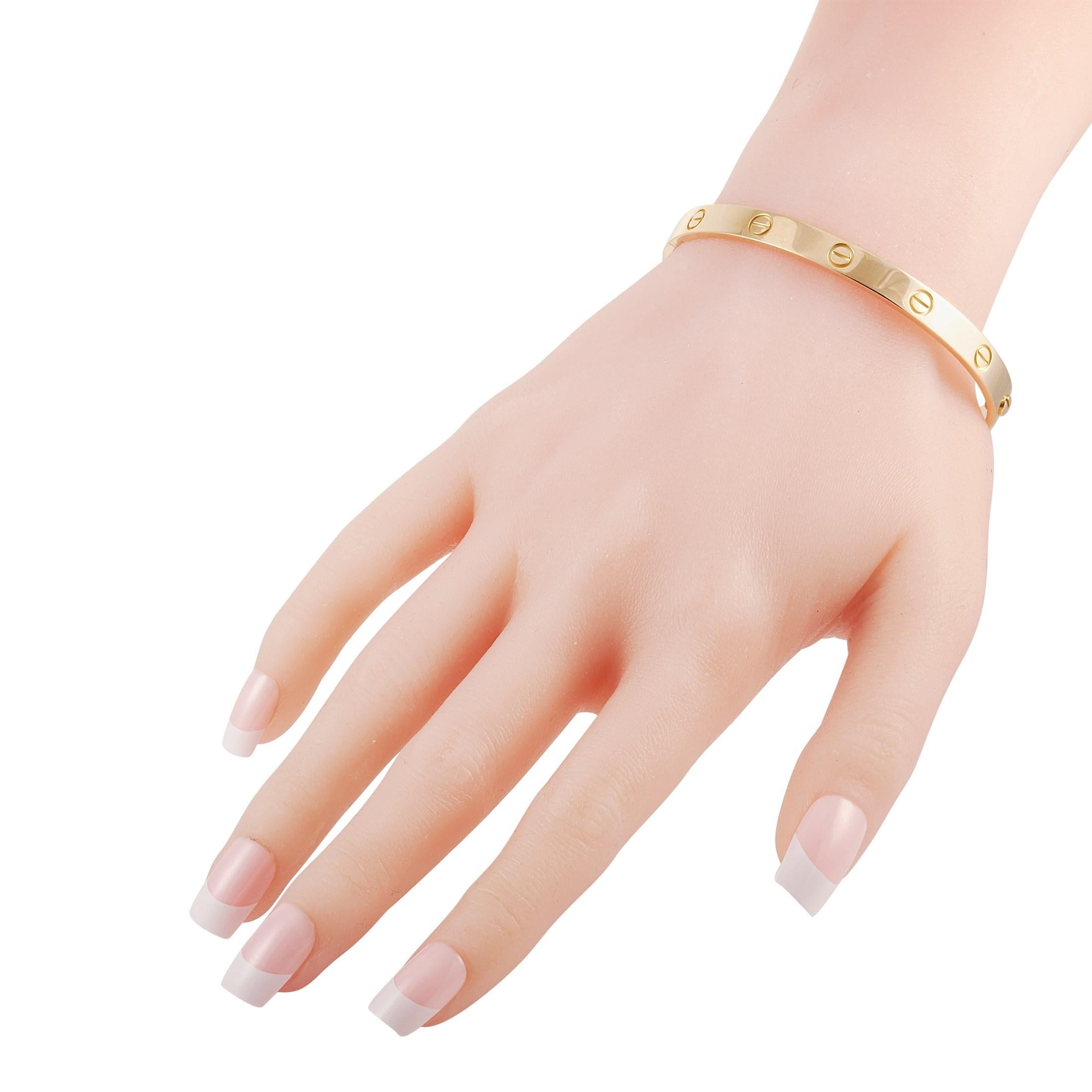 This Cartier 18K Yellow Gold Love Bangle Bracelet is made with 18K yellow gold and features the signature Santos de Cartier screws around the bracelet. The bracelet weighs a total of 34.3 grams and has a diameter of 7.85 inches.

This bracelet is