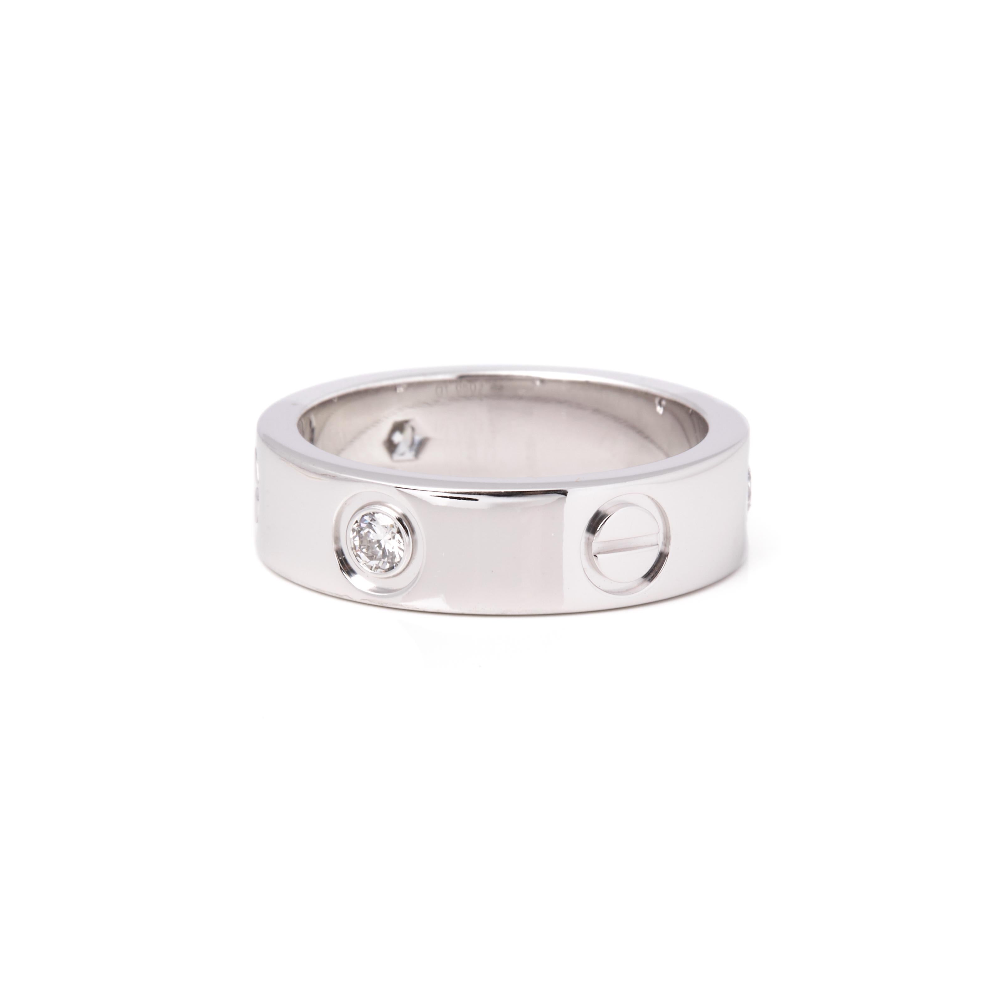 This ring by Cartier is from their Love collection and features three round cut diamonds set with their iconic screw detail onto an 18ct white gold band ring. UK ring size L 1/2. EU ring size  52. US ring size  6. Complete with Xupes presentation