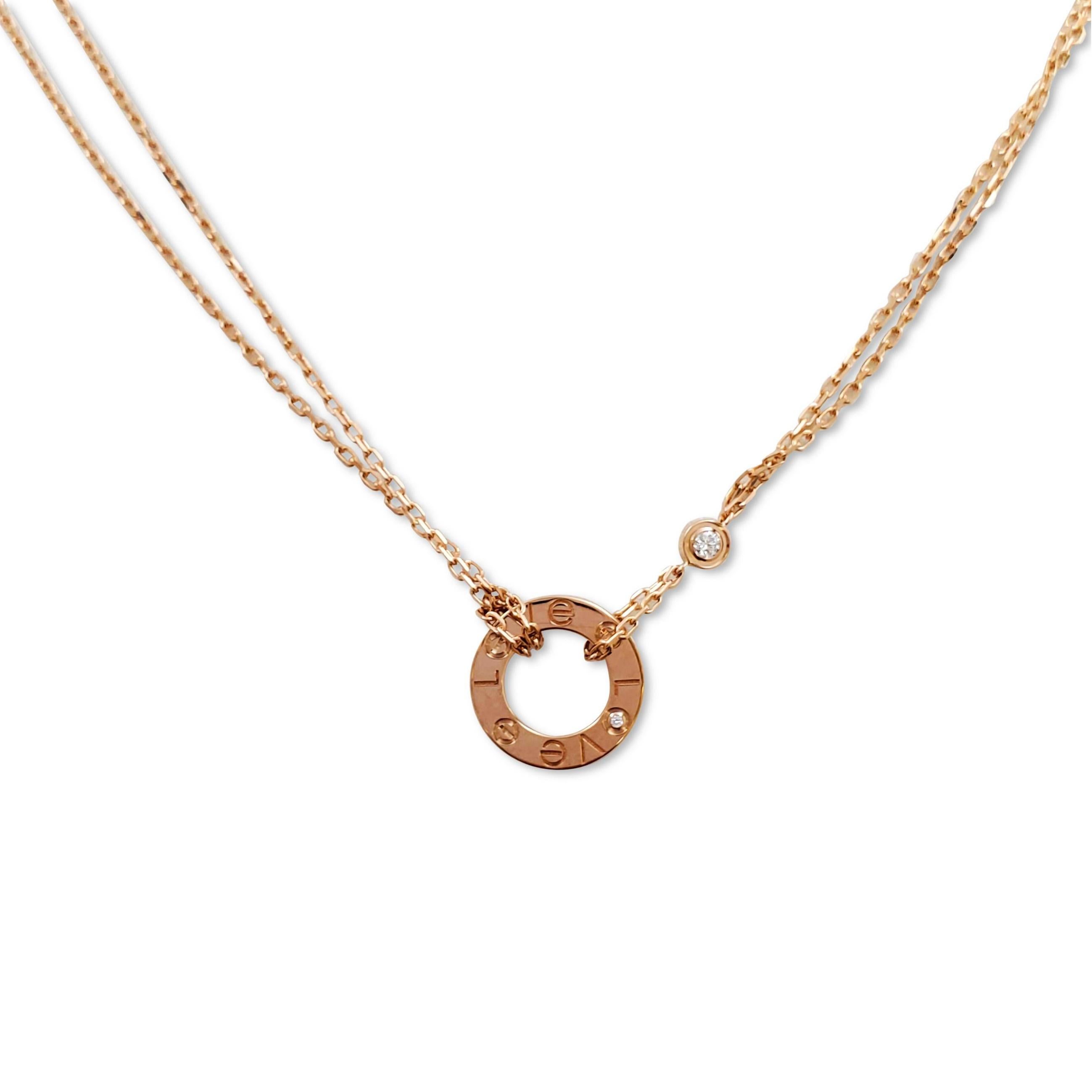 Authentic chain and ring charm necklace from the Cartier 'Love' collection. Crafted in 18 karats rose gold, the double-strand oval-link adjustable chain features a half-inch round ring and screw top motifs set with two round brilliant cut diamonds
