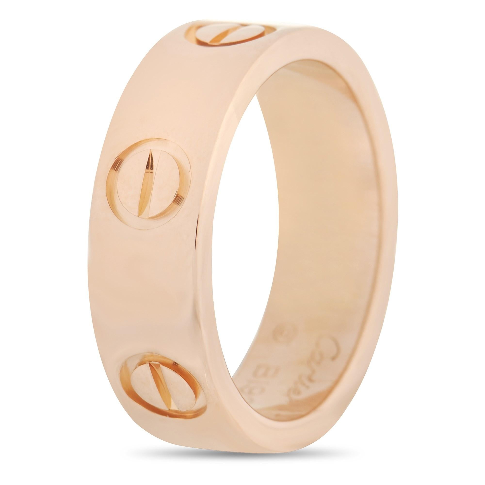 This Cartier LOVE 18K Rose Gold Band Ring is a classic Cartier piece. The simple band is made with 18K rose gold and features the iconic Cartier screw motif. The inside of the band is inscribed with the brand name. The ring has a band thickness of 5