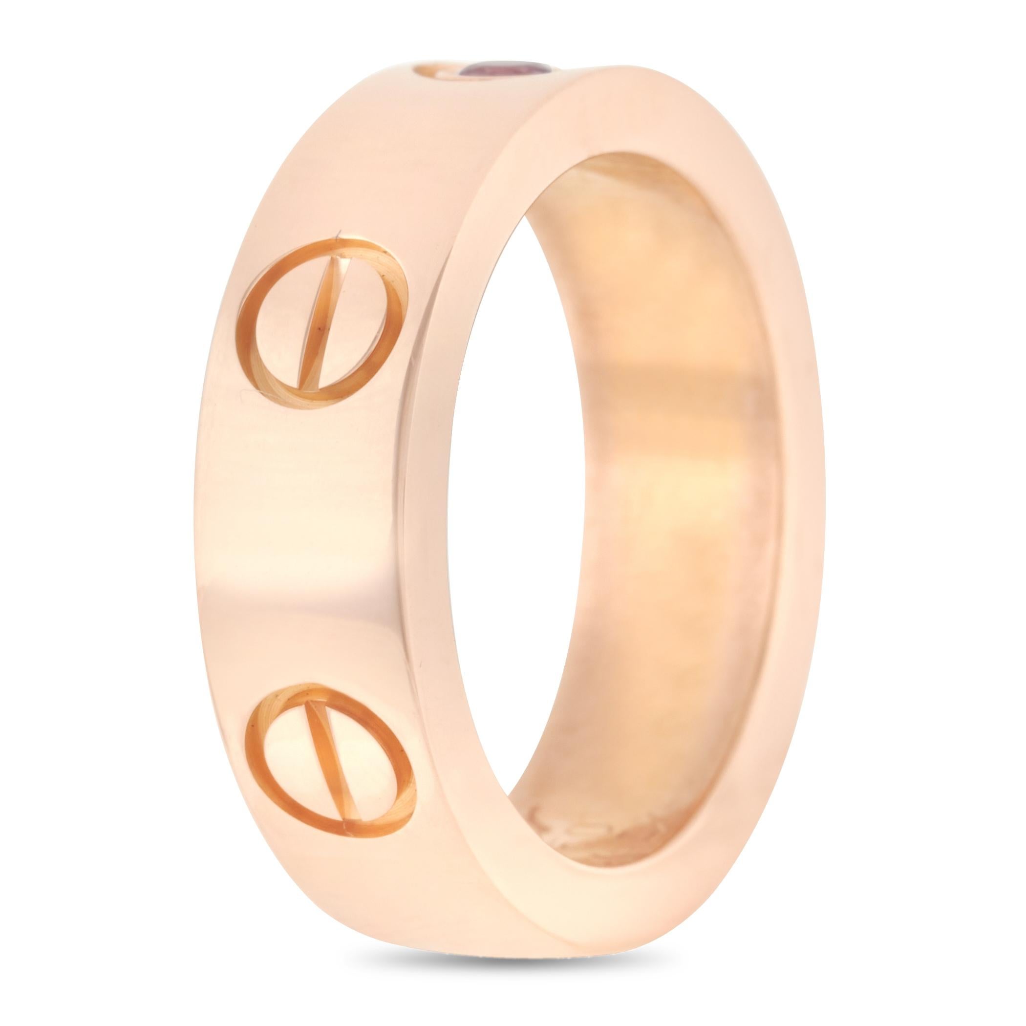 A Cartier Love Ring fashioned from 18K rose gold and set with one pink sapphire. This 5mm rosy band with a rosy gem displays a compelling beauty you'll be so smitten you'll blush. Treat yourself to this pink gold ring and show yourself some love. 
