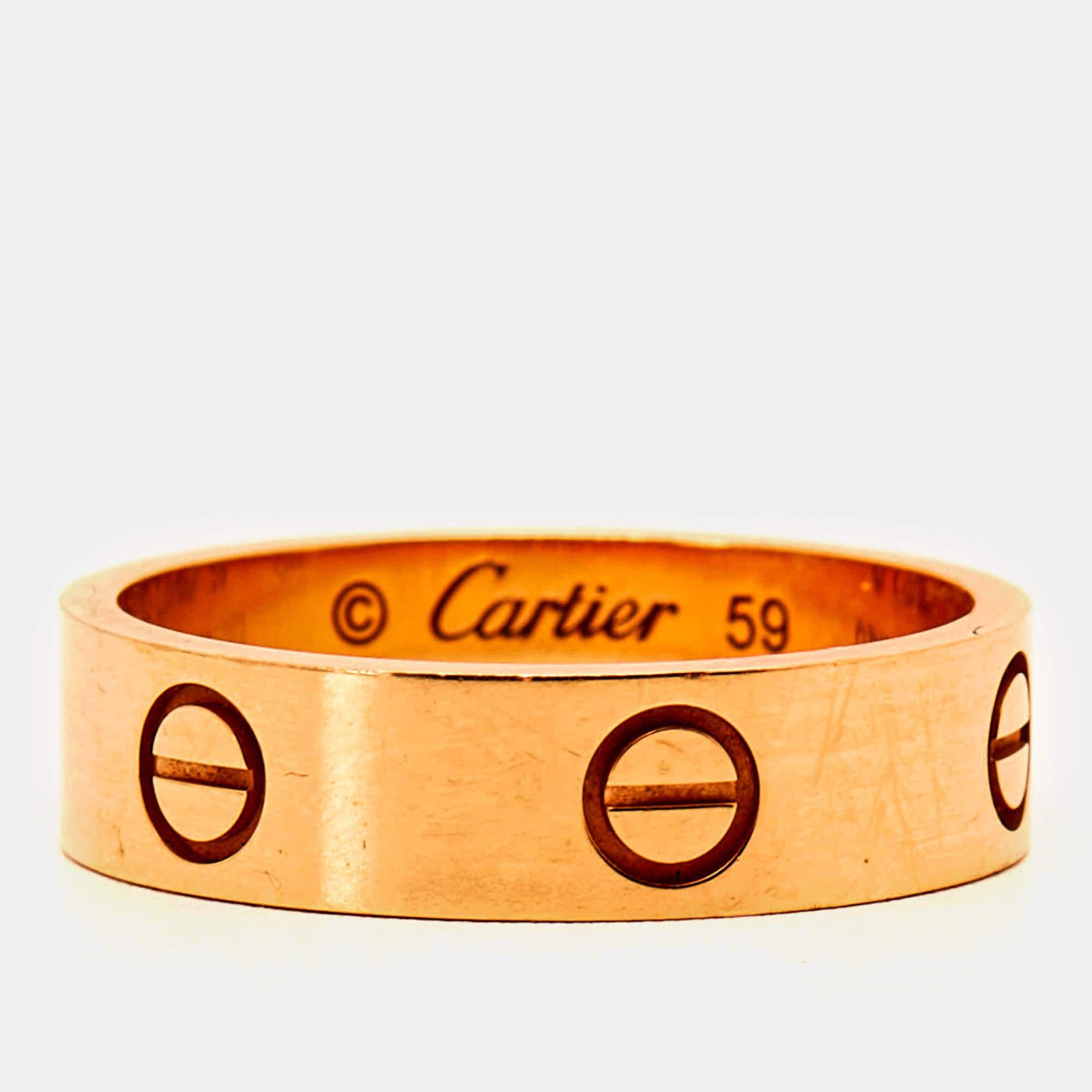 The Cartier ring exudes timeless elegance with its iconic screw motifs symbolizing eternal love. Crafted from lustrous 18k rose gold, this luxurious piece seamlessly combines sophistication and modernity, making it a symbol of enduring commitment