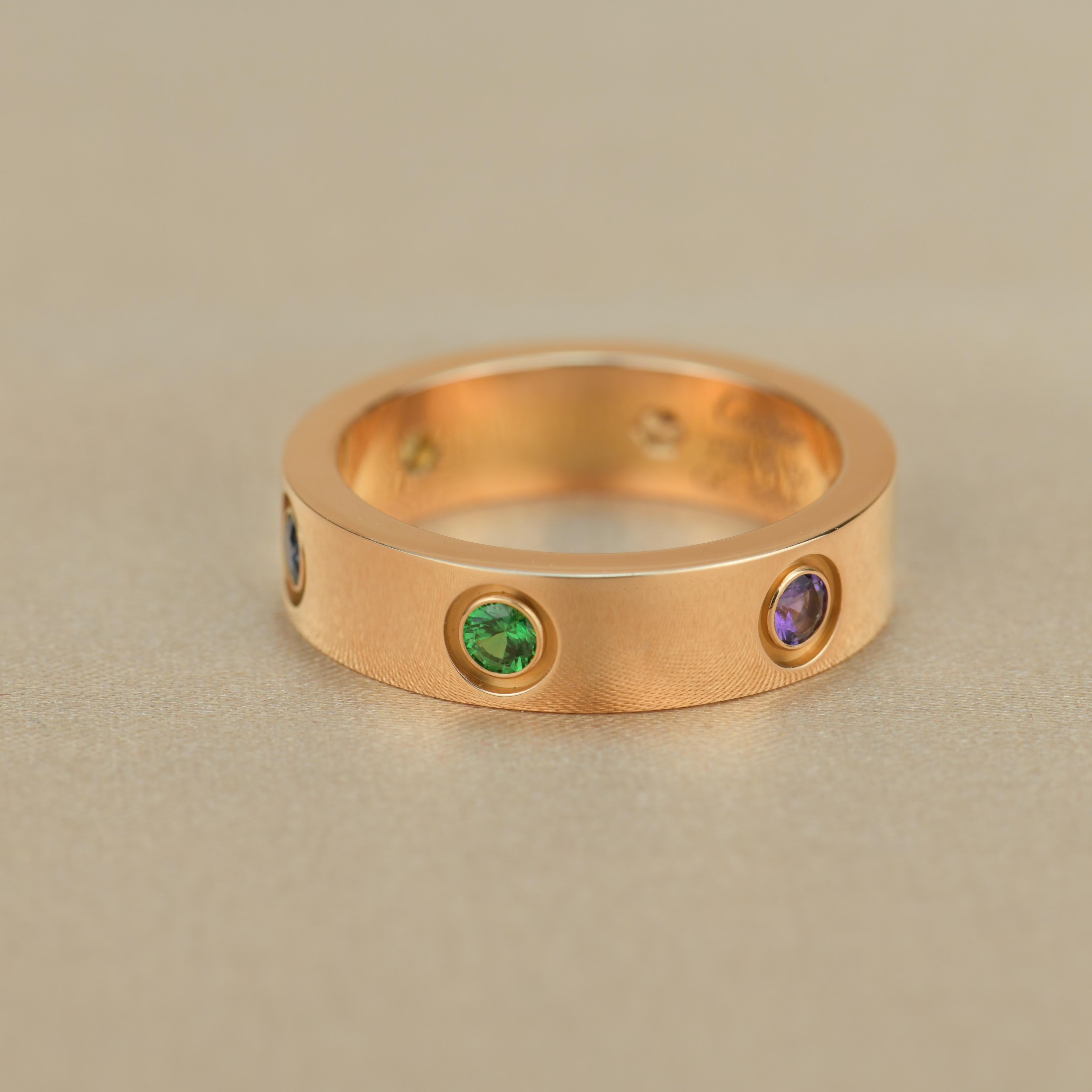 LOVE ring, 18K rose gold, set with 1 pink sapphire, 1 blue sapphire, 1 yellow sapphire, 1 green garnet, 1 orange garnet, and 1 amethyst. Width: 5.5mm.

Dandelion Antiques Code	AT-0833
Brand	                                Cartier
Model	             
