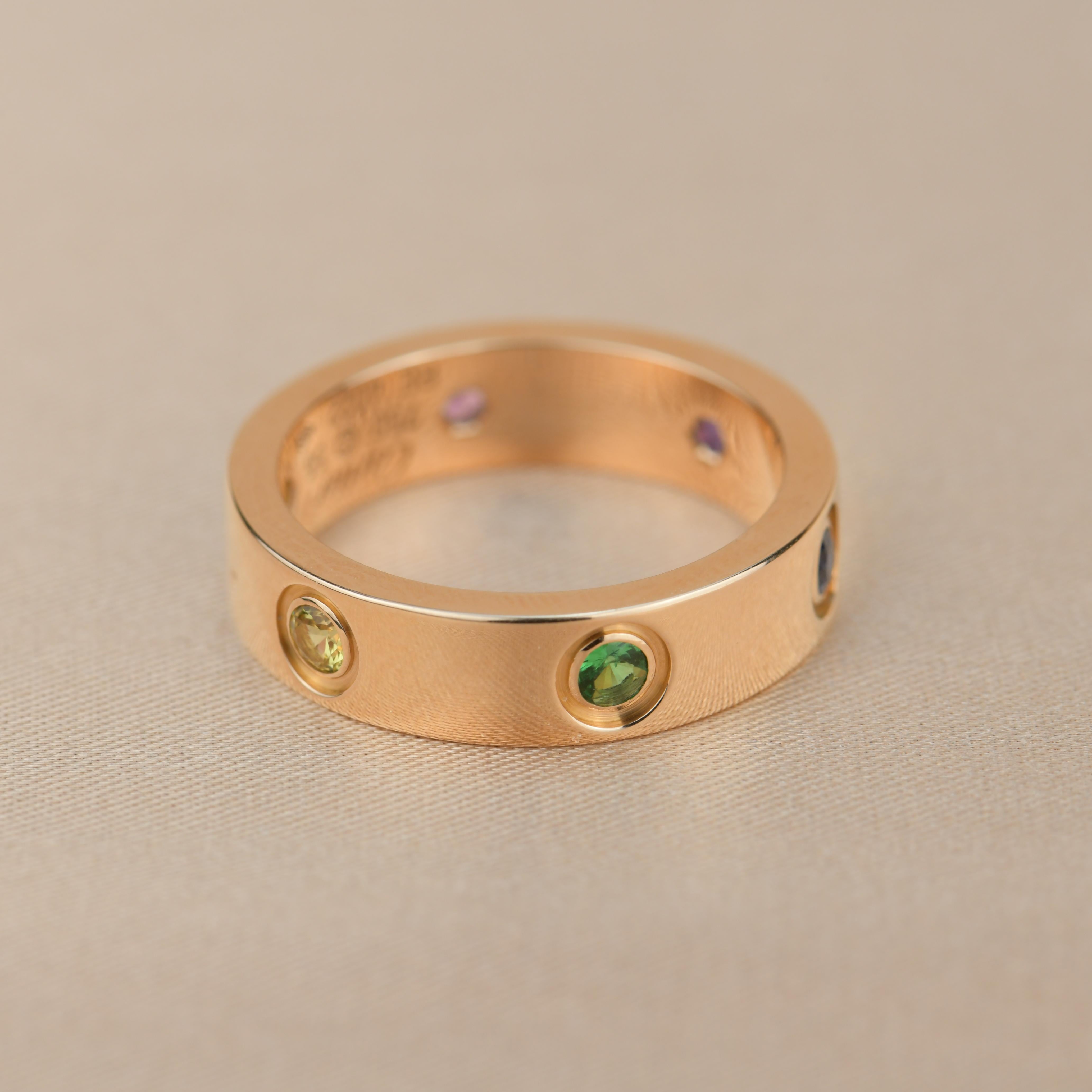LOVE ring, 18K rose gold, set with 1 pink sapphire, 1 blue sapphire, 1 yellow sapphire, 1 green garnet, 1 orange garnet, and 1 amethyst. Width: 5.5mm.

Dandelion Antiques Code	AT-0889
Brand	                                Cartier
Model	             