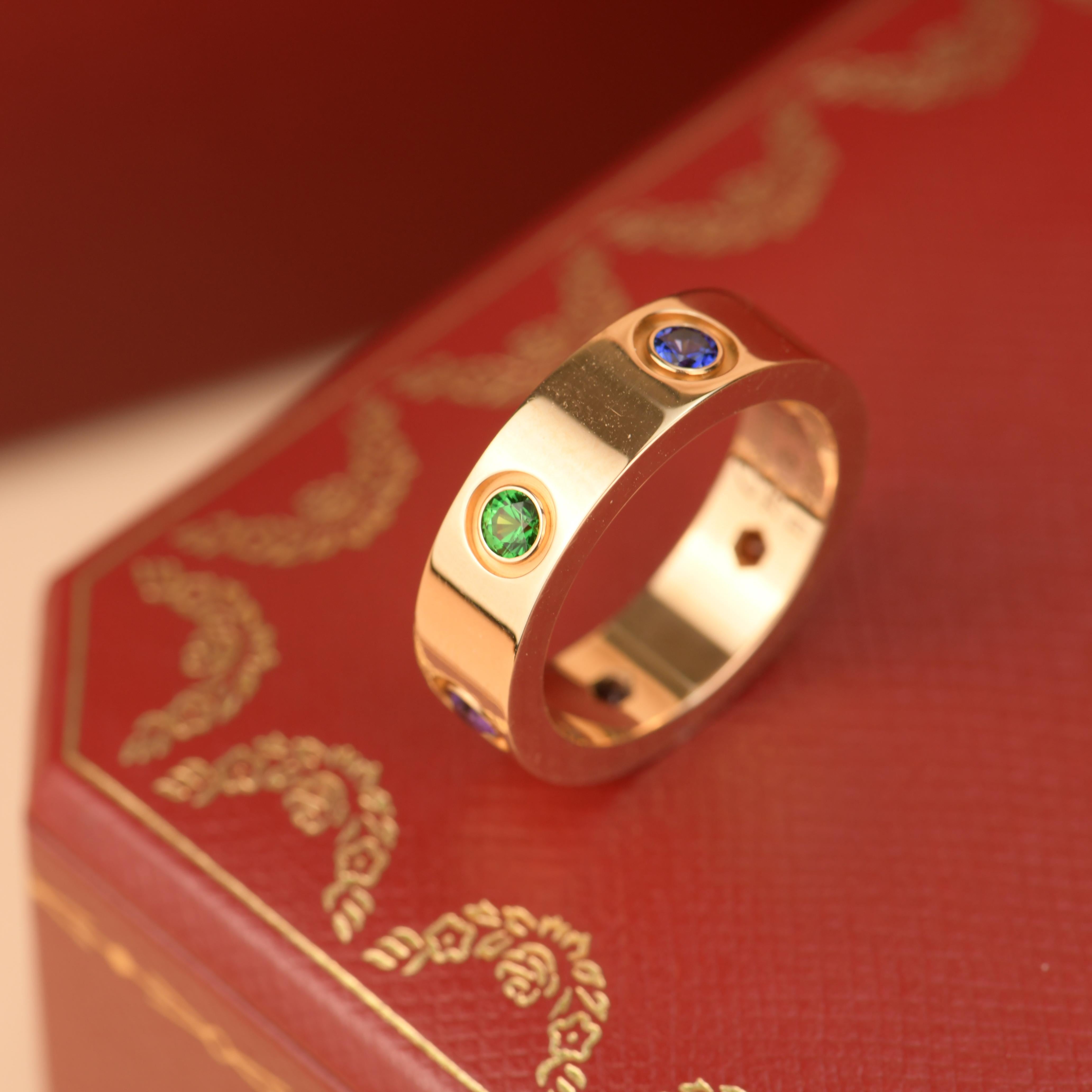LOVE ring, 18K rose gold, set with 1 pink sapphire, 1 blue sapphire, 1 yellow sapphire, 1 green garnet, 1 orange garnet, and 1 amethyst. 

Dandelion Antiques Code	AT-1031
Brand	                                Cartier
Model	                          