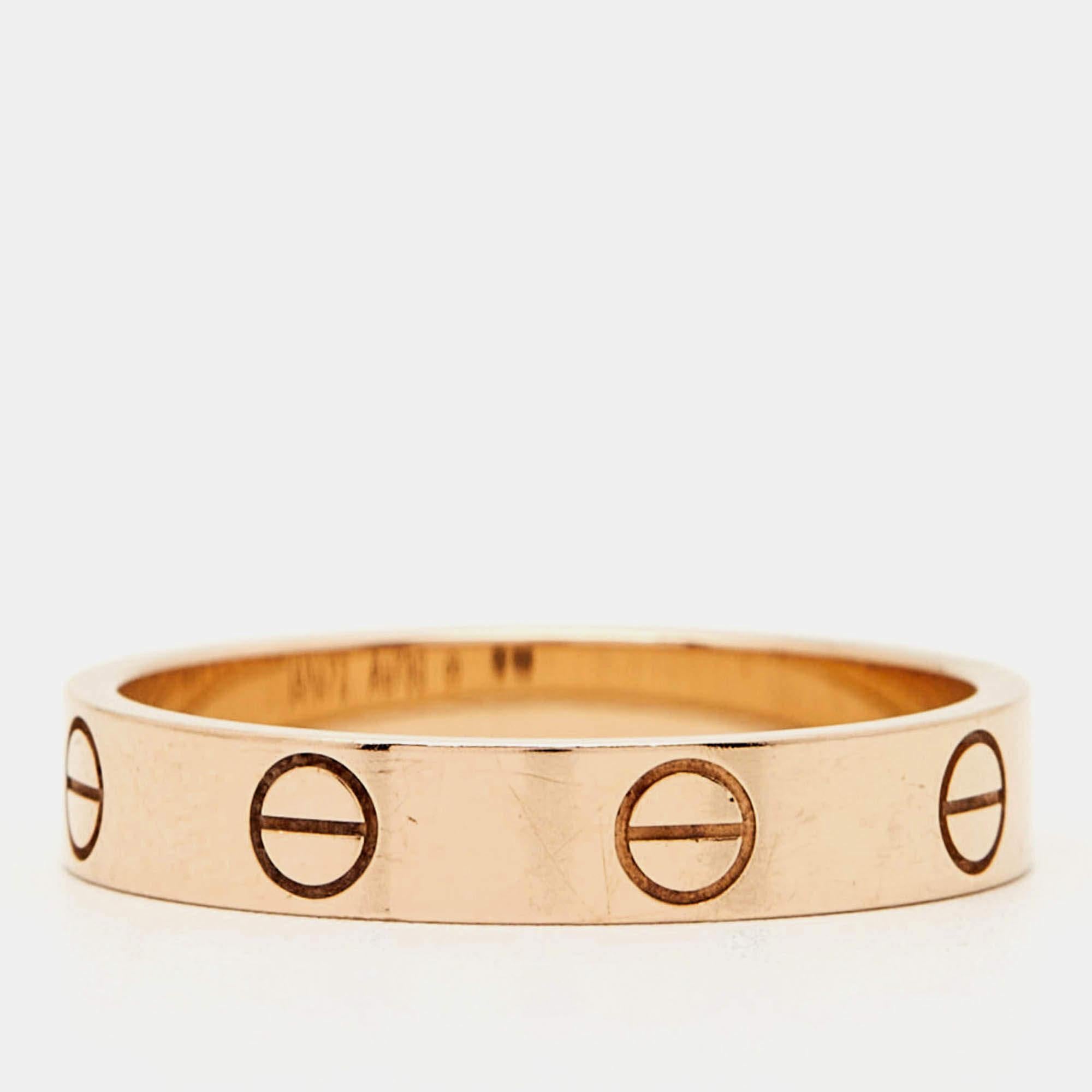 The Cartier Love wedding band ring embodies timeless romance with its sleek iconic design. Crafted from luxurious rose gold this ring features signature screw motifs that symbolize everlasting love and commitment. Perfect for sealing your bond this