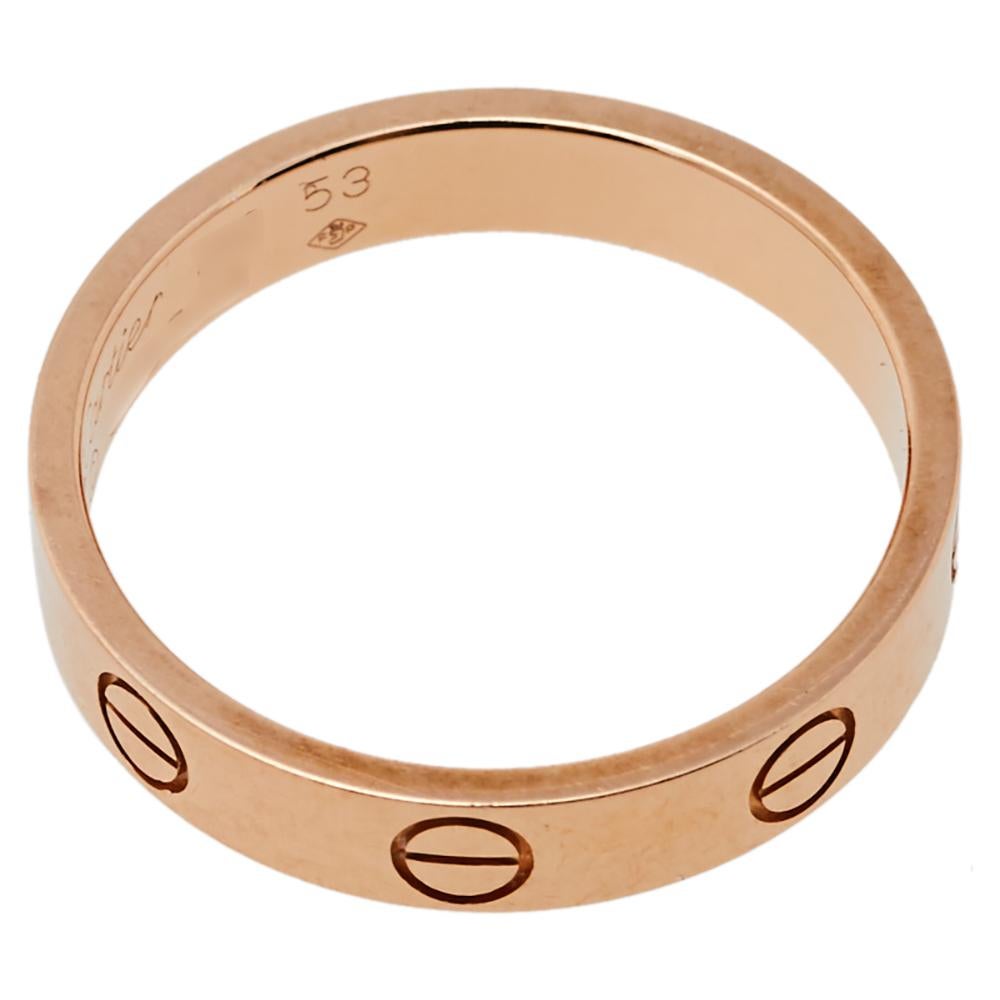 One of the most iconic designs from the house of Cartier, this stunning Love ring is a symbol of style and luxury. Constructed in 18K rose gold, this wedding ring has the signature screw details all around the surface. The ring is sure to become