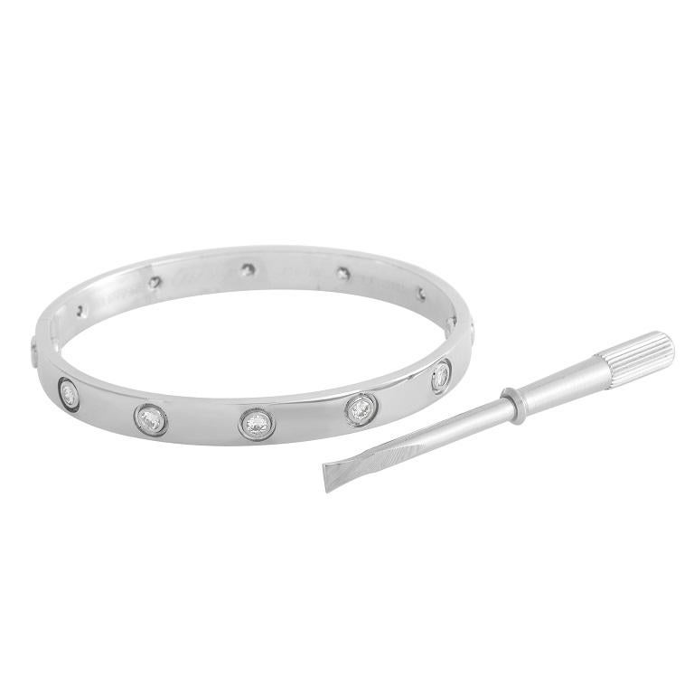 A series of 10 round-cut diamonds add a touch of sparkle to this iconic bracelet from the Cartier LOVE collection. Sleek and simple, this piece is crafted from shimmering 18K White Gold. This bracelet is a size 16 and measures 6.3” long. 