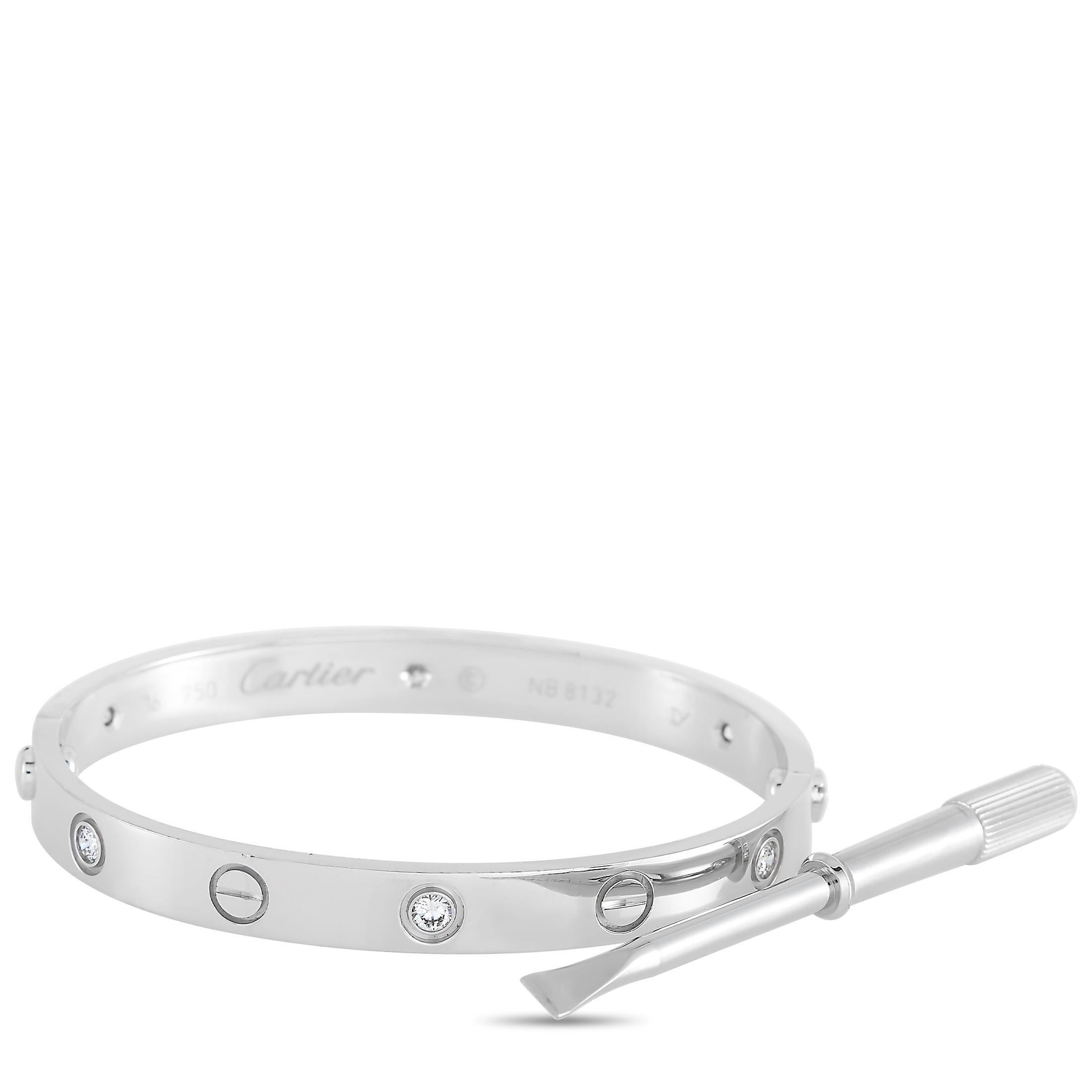 This LOVE bracelet is a classic Cartier offering. The bangle is made with 18K white gold and features the iconic Cartier screw motif and is set with six round diamonds. The inside of the bangle is inscribed with the brand name. The bracelet has a