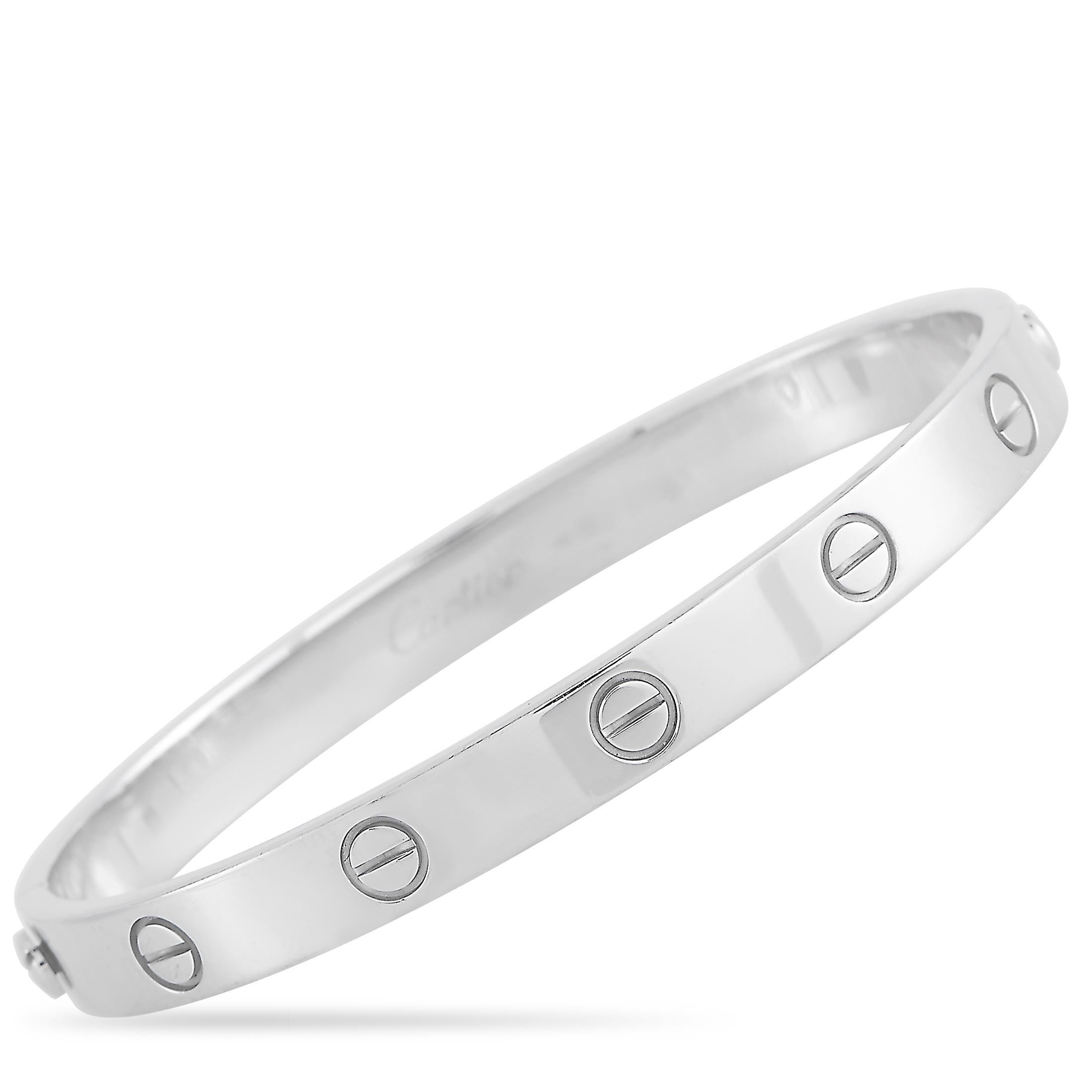 This LOVE bracelet is a classic Cartier offering. The bangle is made with 18K white gold and features the iconic Cartier screw motif. The inside of the bangle is inscribed with the Cartier brand name. The bracelet is a size 17, and is 6.7 inches in