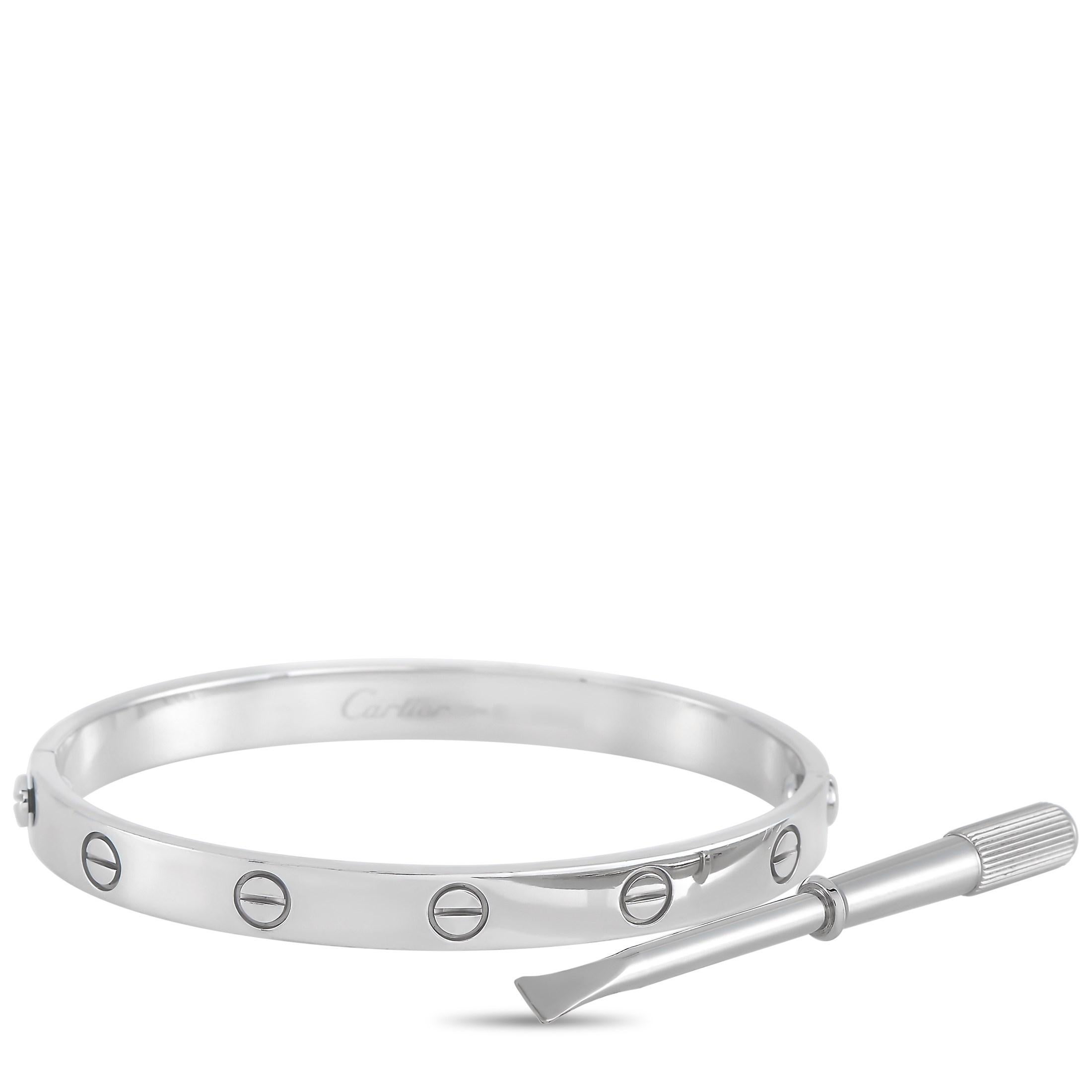 This LOVE bracelet is a classic Cartier offering. The bangle is made with 18K white gold and features the iconic Cartier screw motif. The inside of the bangle is inscribed with the Cartier brand name. The bracelet is a size 16, and has a diameter of