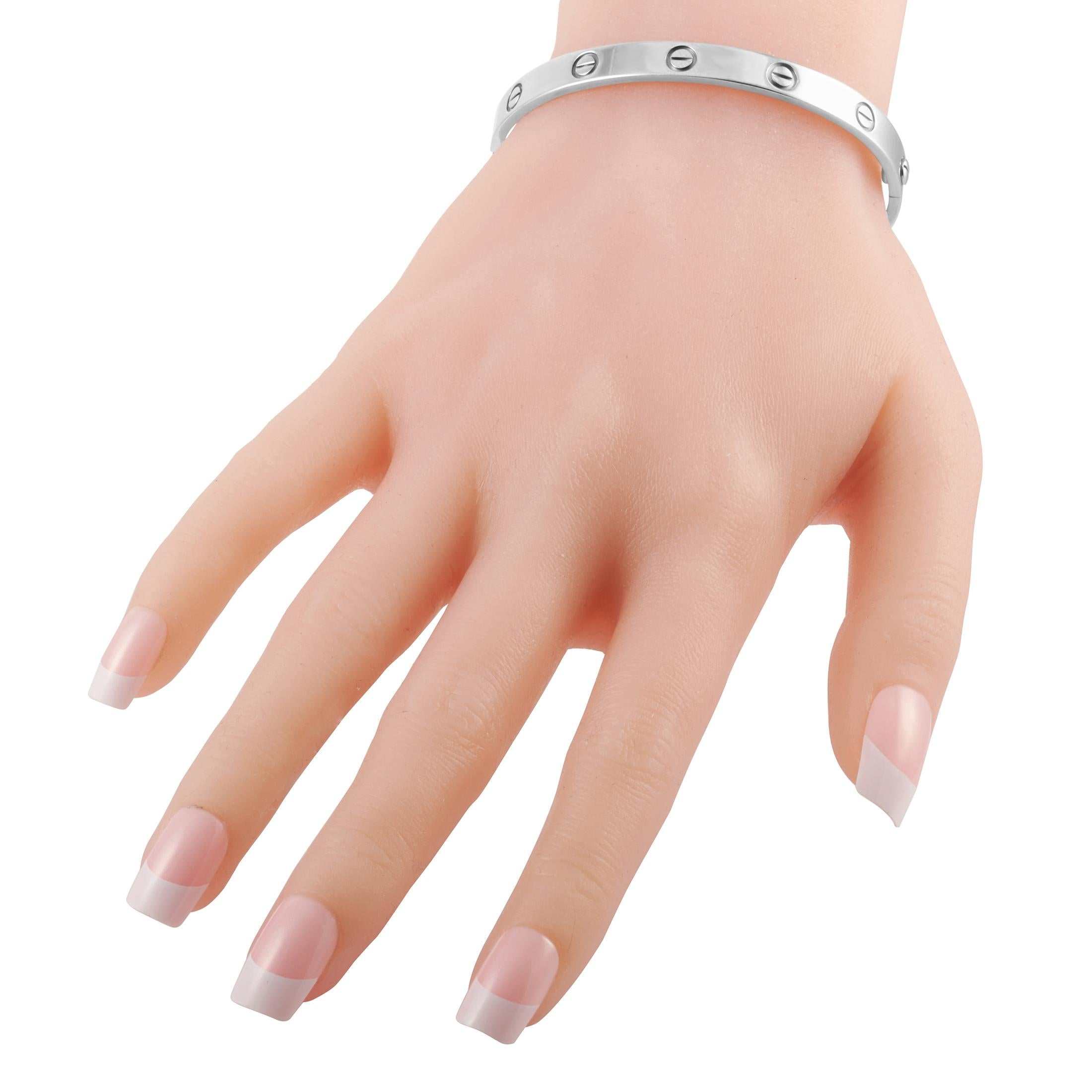 This Cartier LOVE bracelet is an iconic luxury piece that will never go out of style. Crafted from 18K White Gold, this bangle-style bracelet features a series of the brands instantly recognizable circular motifs. Chic, sophisticated, and incredibly