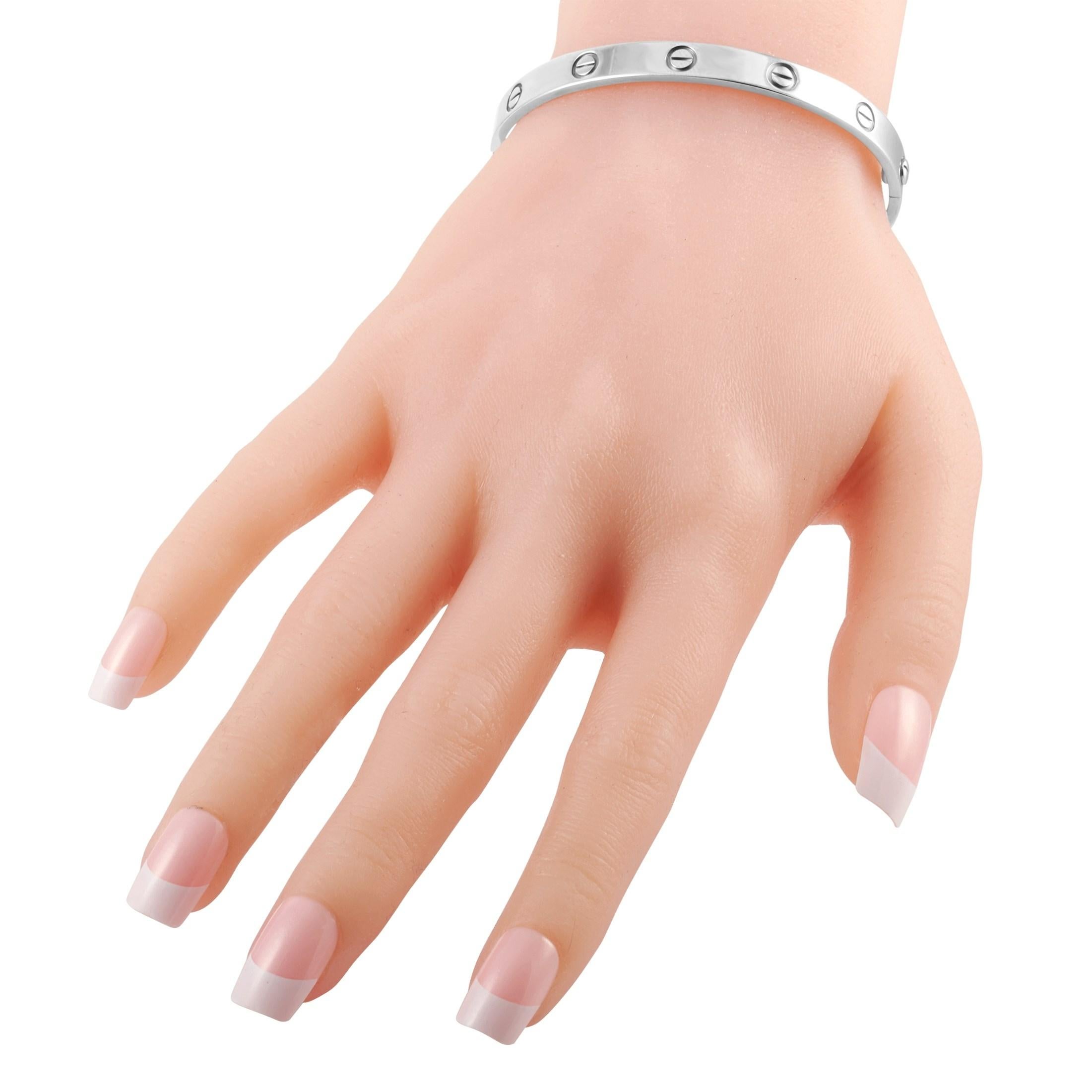 This size 17 Cartier 18K White Gold Love Bracelet is a versatile wrist accessory that's packed with style and meaning. It features a solid white gold band with evenly spaced screws. The clasp is secured by a special screwdriver. Locking this onto