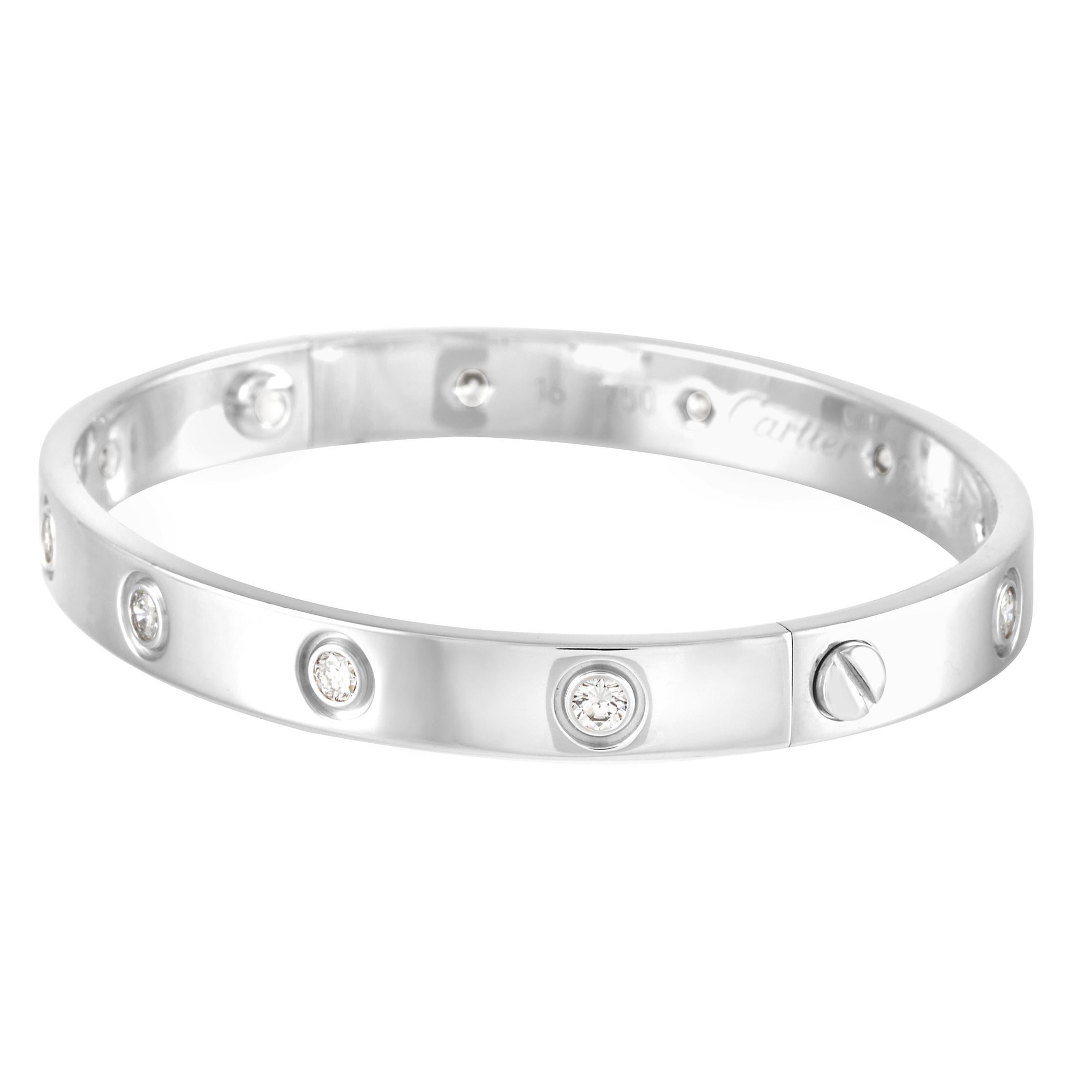 This Cartier LOVE 18K White Gold Diamond Bangle Bracelet is a classic Cartier offering. The simple bangle is made with 18K white gold and 10 bezel set round diamonds. The inside of the bangle is inscribed with the brand name. The bracelet has a
