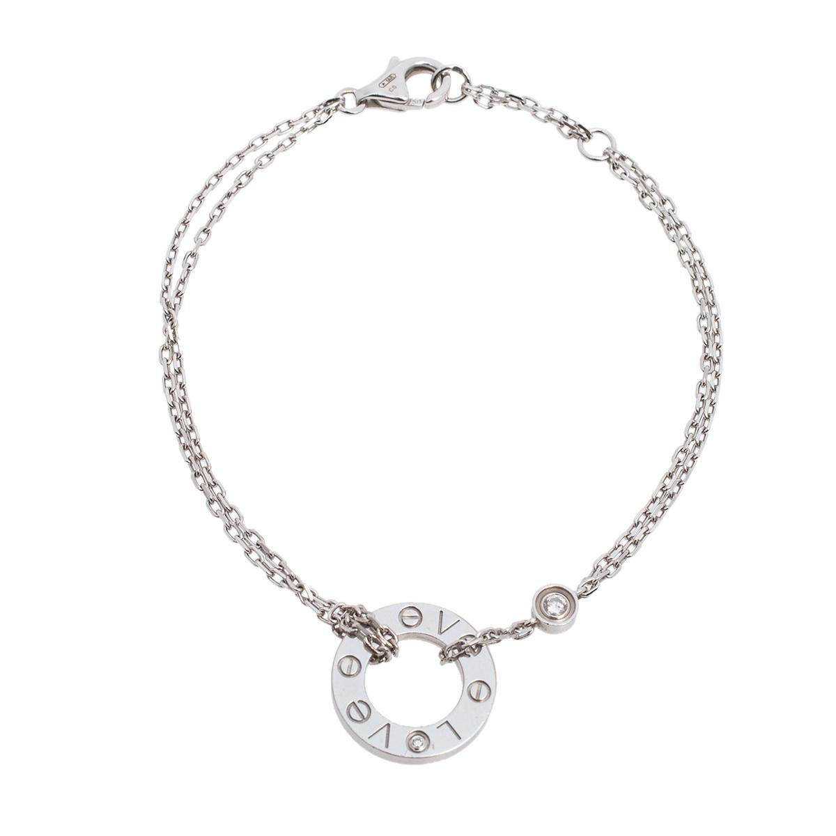 Celebrate timeless love with this bracelet from Cartier's Love collection. It is made from 18k white gold and the chains hold a diamond and a circular charm detailed with a diamond and engraved with 'LOVE'. Finished with a lobster clasp, this iconic
